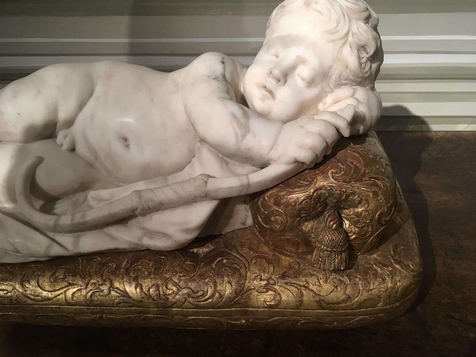 Late 17th Century White Marble Carved Child Nude Cupid Sculpture on Gilded Base In Good Condition For Sale In Brescia, IT