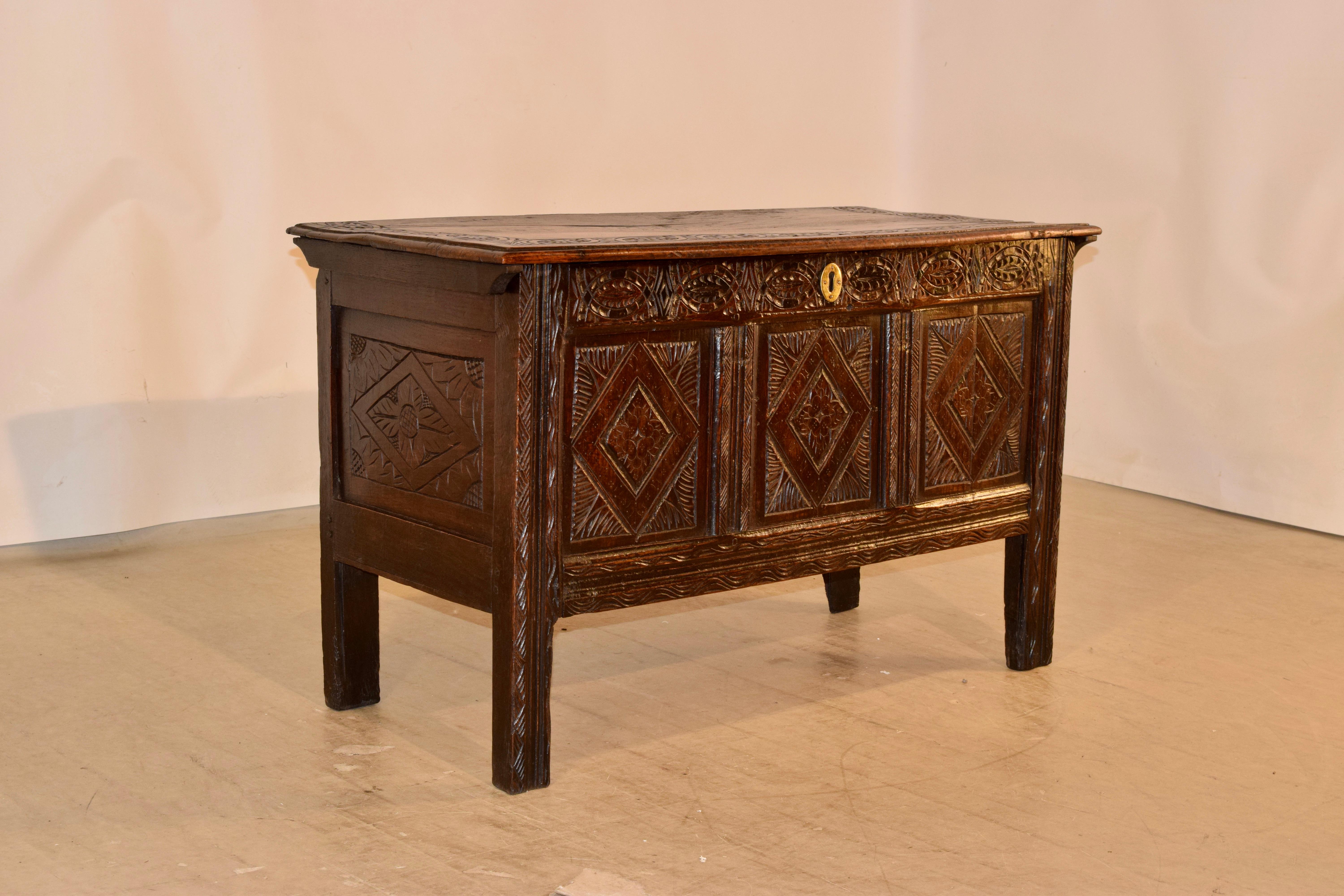 Circa 1690-1710 oak blanket chest from England with wonderful color and carving. The top has a beveled edge and is banded with hand carved lunette designs, over a wonderfully hand carved decorated case. The case has hand paneled and carved sides and