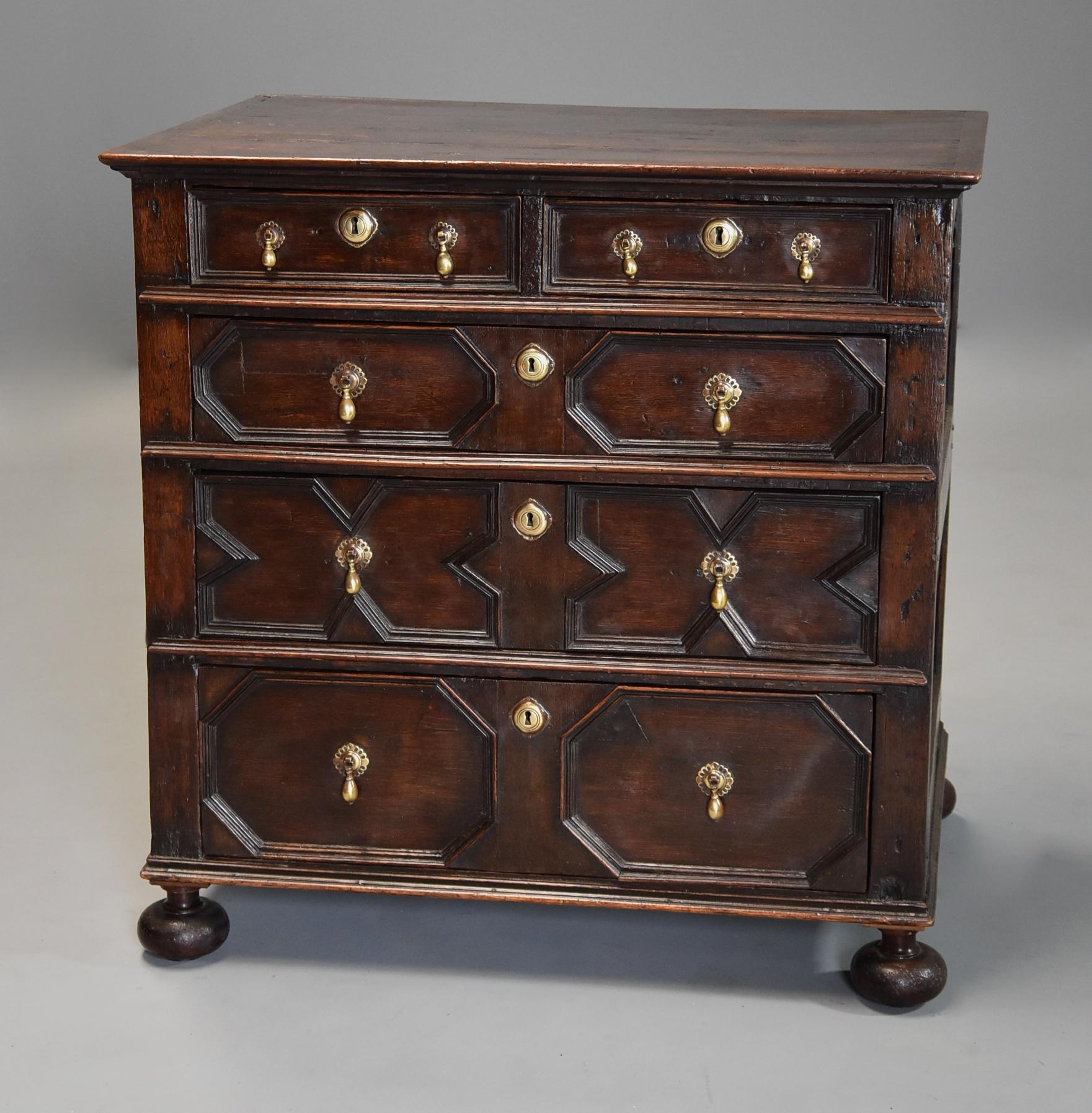 A late 17th-early 18th century oak moulded front (or joined) chest of drawers. 

This chest of drawers consists of a four plank top with moulded edge leading down to four graduated drawers with applied geometric moulded designs to the front, this