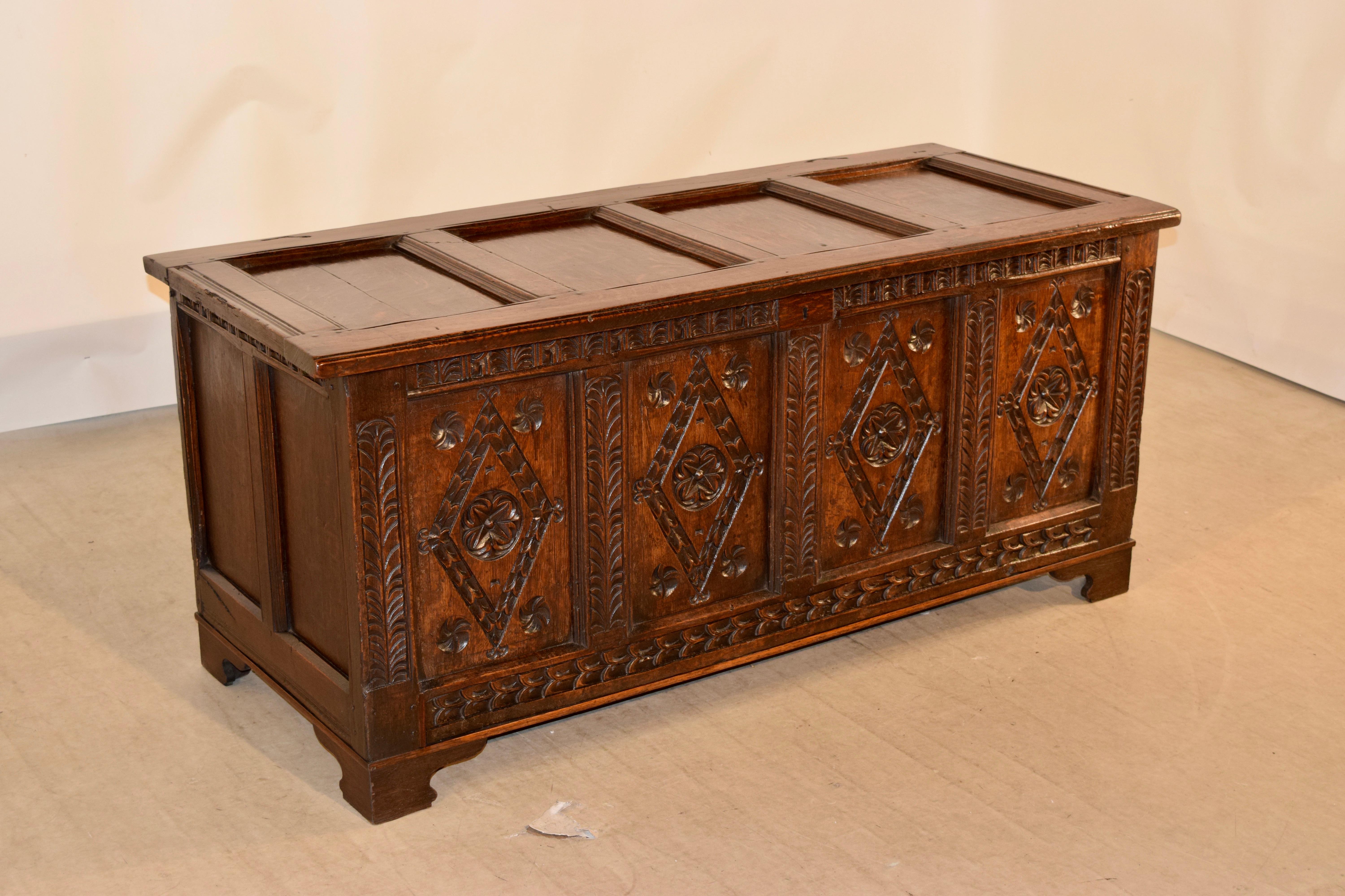 Period William and Mary oak blanket chest from England with four panels in the top, following down to sides with two panels, and the front of the chest with four hand carved decorated panels and surrounded by hand carved decoration on all of the