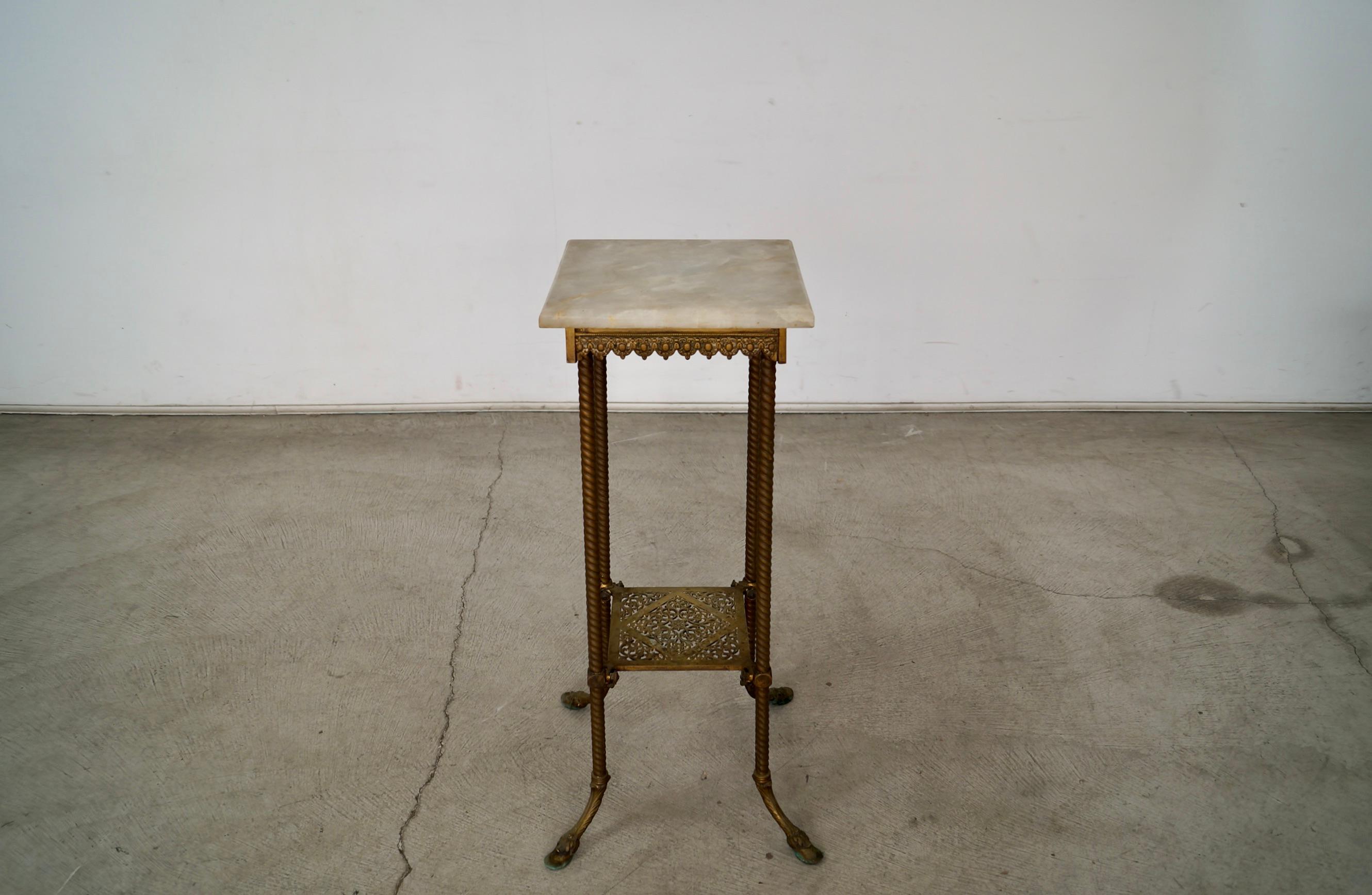 Beautiful Victorian stand for sale. Can be used for as an art pedestal, and is the perfect size. It's made of solid brass with intricate details, and is an original antique piece. It has a solid onyx top that sits on top and doesn't move since the