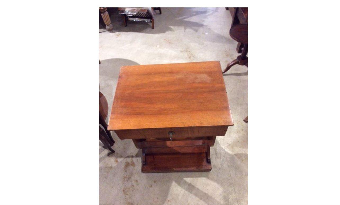 Found in France, this Late 1800s French Side table was crafted with a lift top that opens to reveal a mirror and storage which lends itself to be used as a vanity. Resting on curved form legs and a platform base, this piece would make a great
