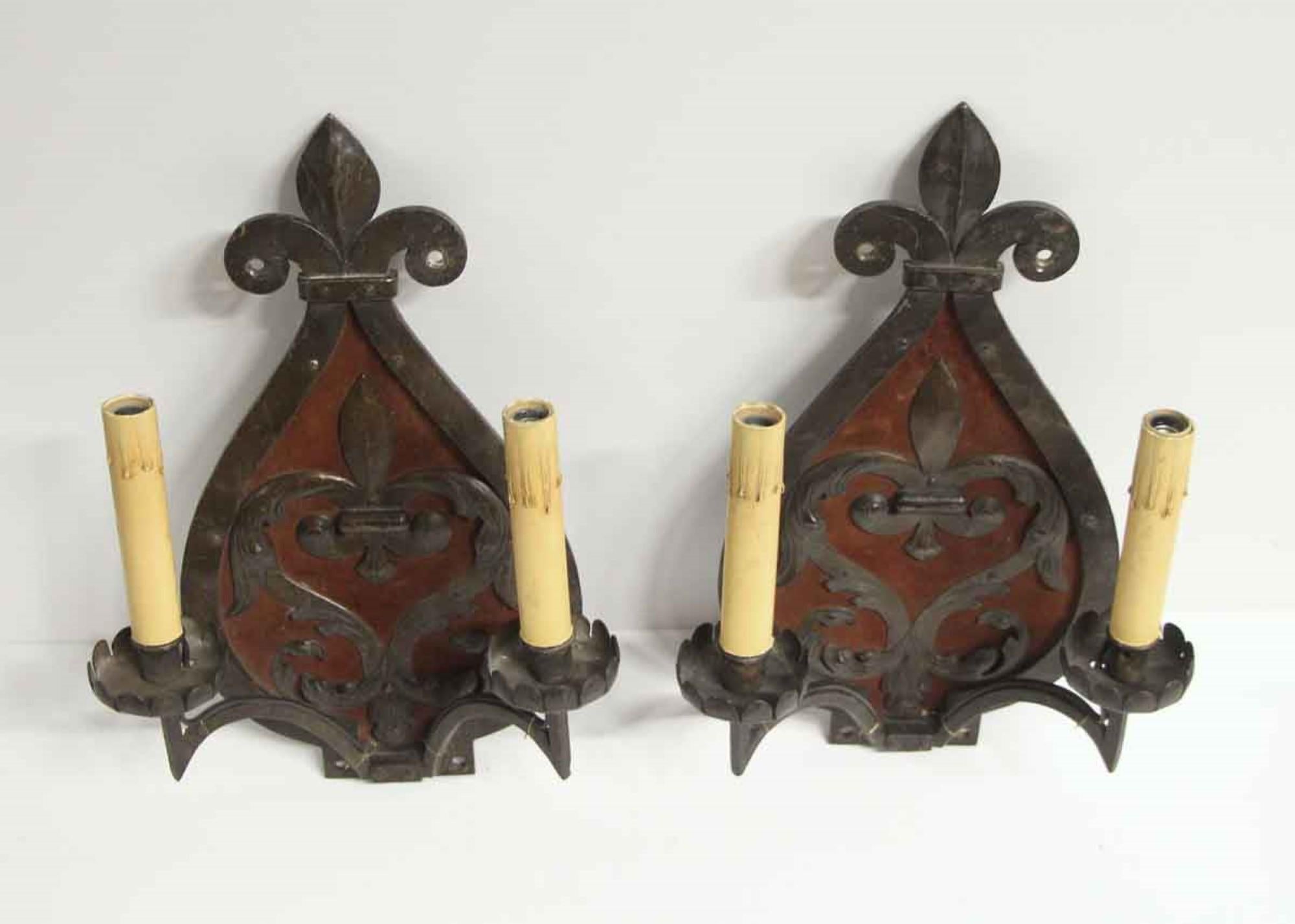 19th century French wrought iron double arm sconces with a deep red fabric center. Hammered and riveted detail decorates this unique pair. Price includes restoration. Priced as a pair. This can be seen at our 400 Gilligan St location in Scranton, PA.