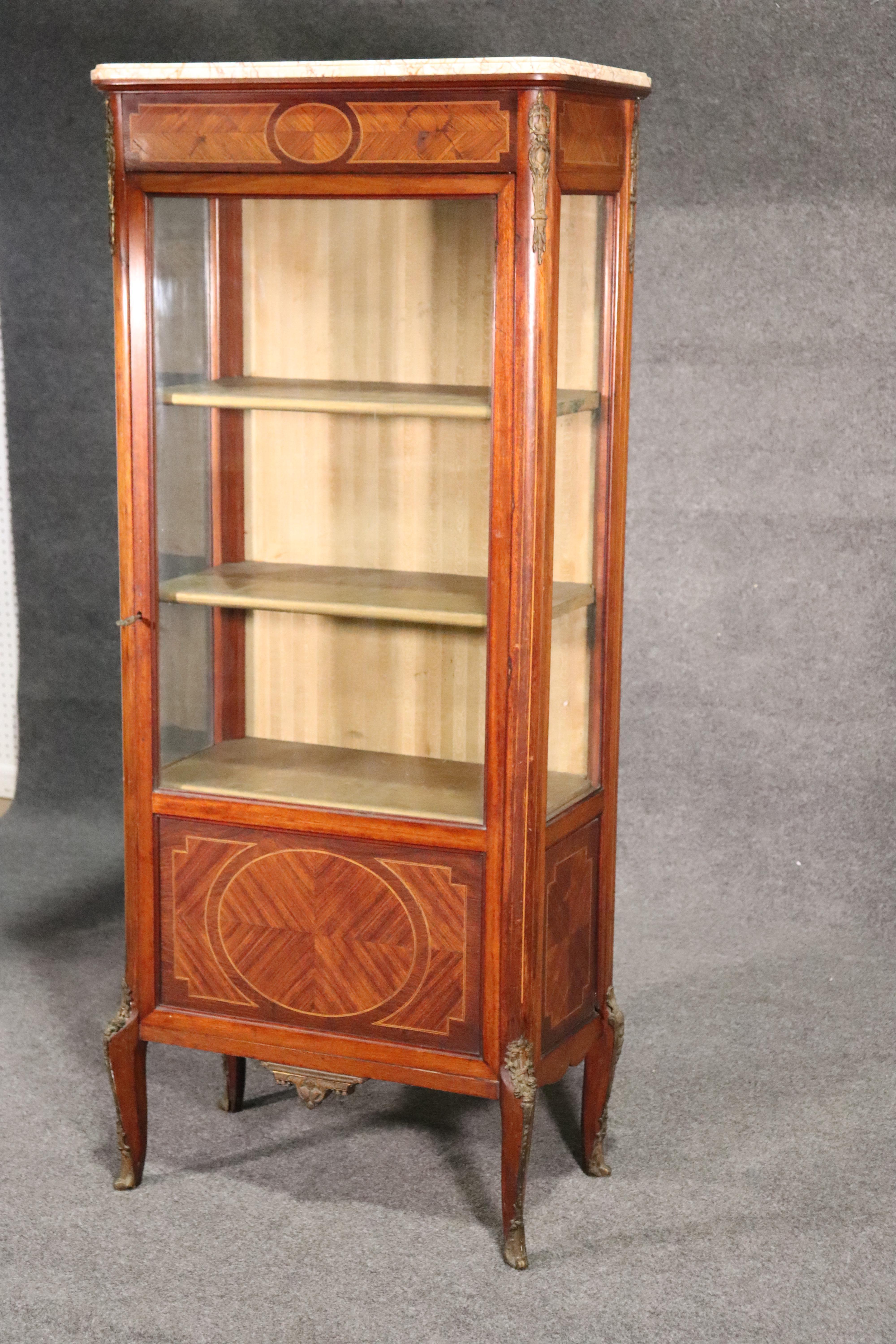 This is a nice original French 1890s Louis XV vitrine. The china cabinet is entirely original and has an original finish and patina. The marble is in good condition with no damage. The vitrine measures 64 tall x 27 wide x 14 inches deep.