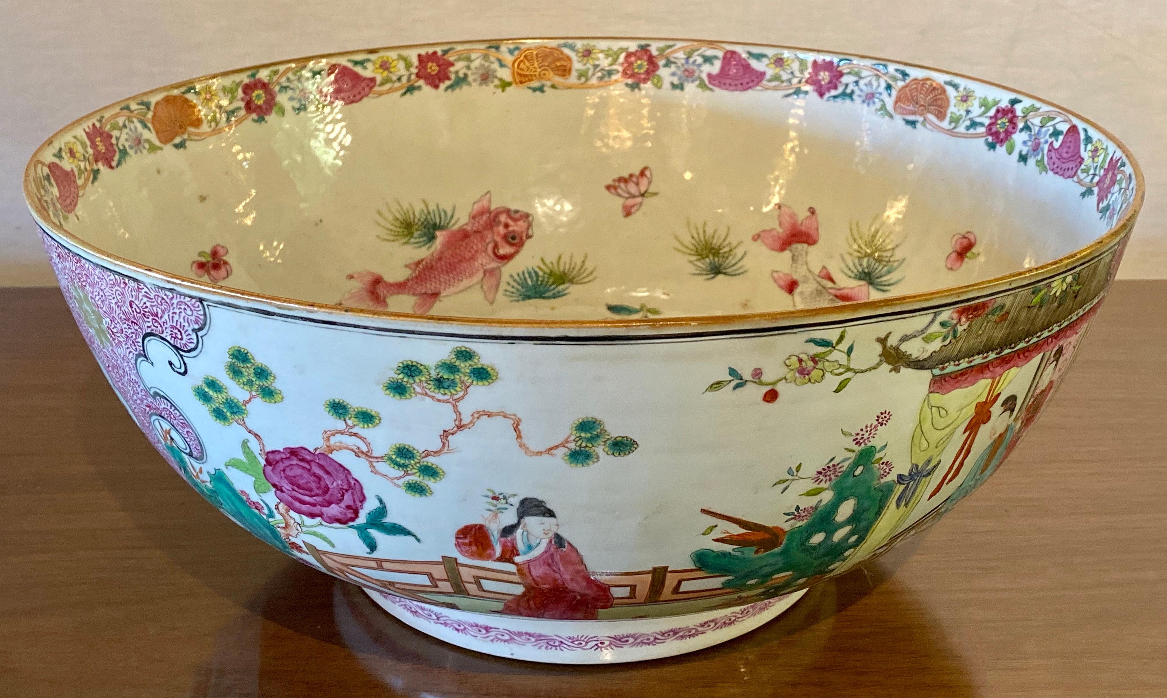 Fine Ch'ing dynasty export Famille Rose large punch bowl, hand-painted porcelain, in very colorful everyday scenes of the upper socioeconomic level of Chinese society during the period of the late 18th century (circa 1785). Fruit, floral, and avian
