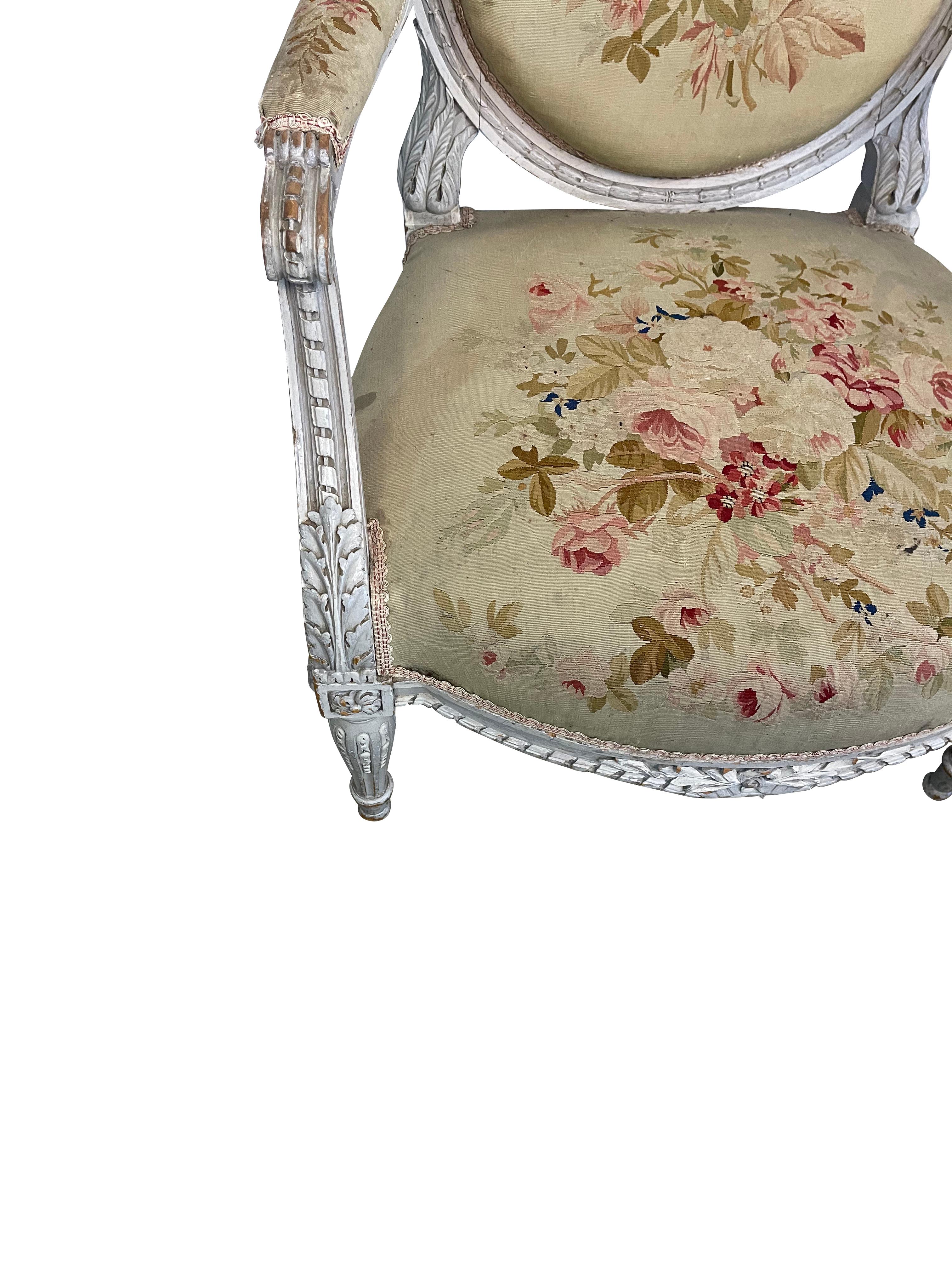 Lovely original carved Louis XVI style chairs with original Aubusson tapestry upholstery. A pair of Louis XVI style fauteuils or armchairis in their original condition ready to be reupholstered .  They ate extemely sturdy and have very beautiful