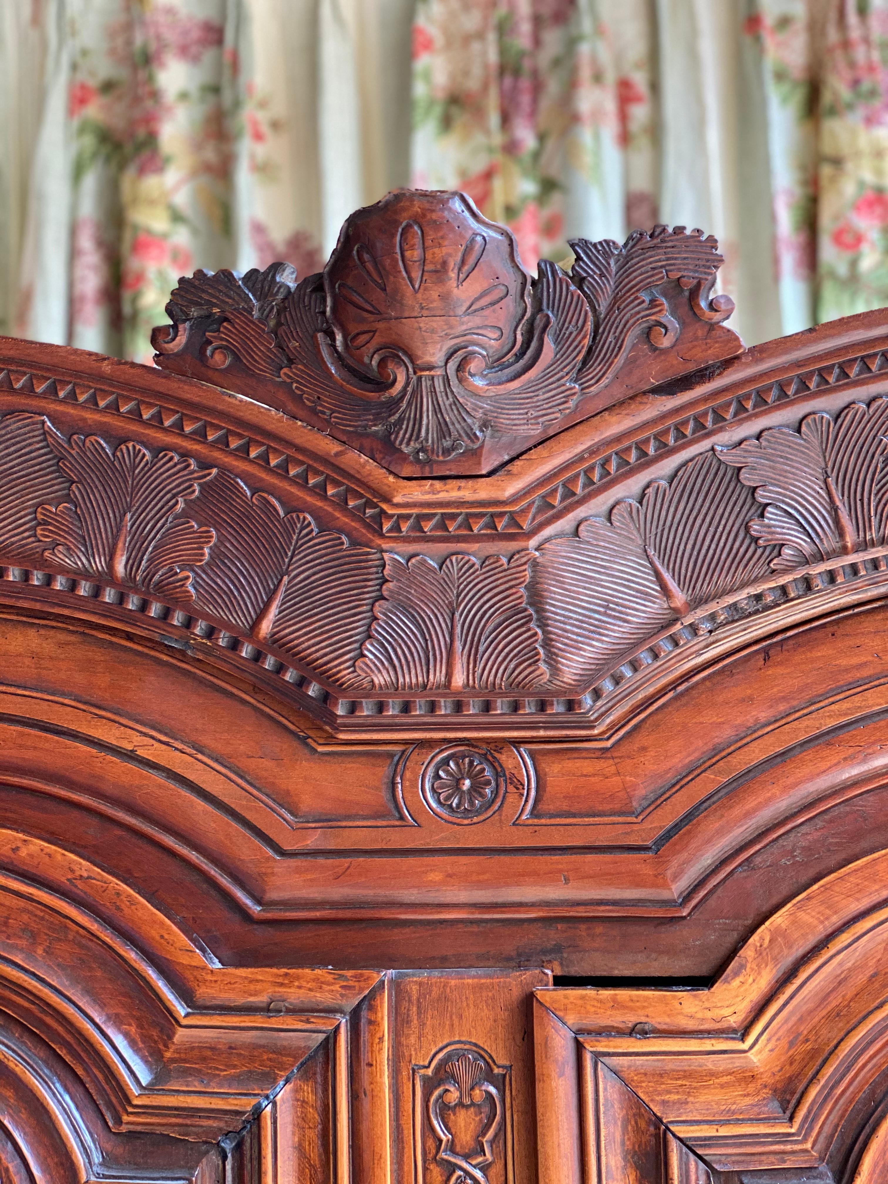 This Armoire, attributed to J.B. Depouez, features a large double bonnet
cornice above two tall doors, arched in the upper section. Adorned with
sawtooth accents above and below stylized oak leafe details on crown.
Deep set moldings are in the late