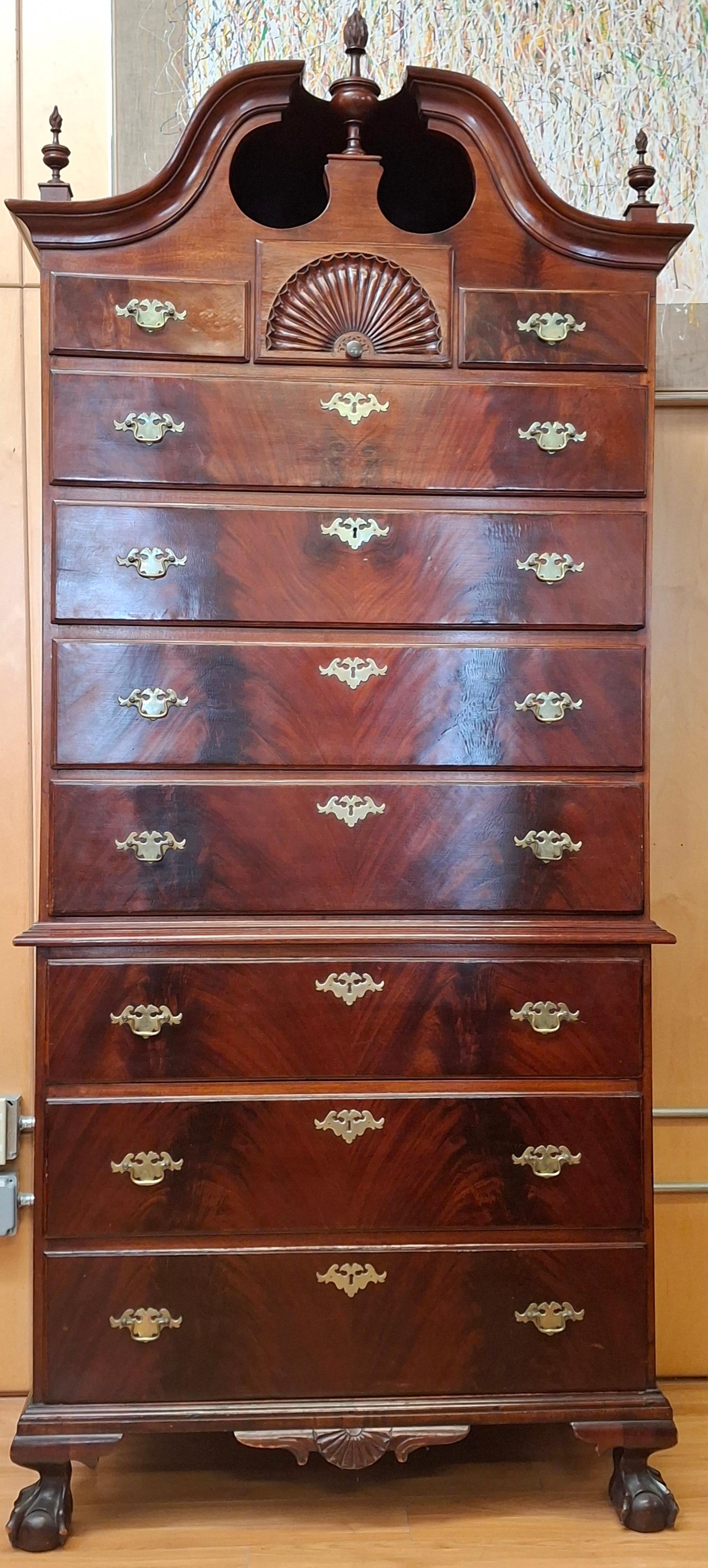 Late 18th century American chippendale mahogany chest on chest with later bonnet. The top
 section with three short drawers, the center having a shell carving, over three long graduated drawers.  The base with
 three long graduated drawers, a shell