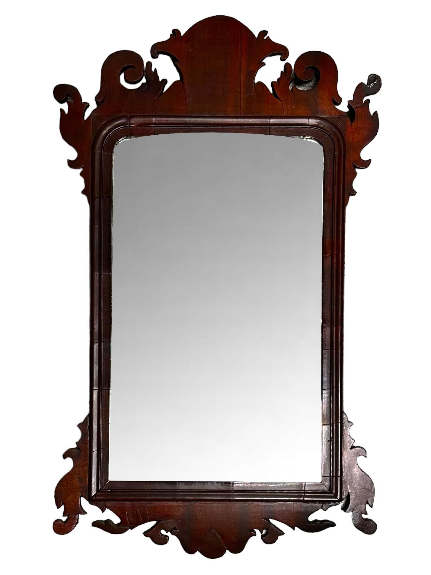 A late 18th century American wooden mirror with its original glass. The back and everything looks original. Only some of the nails have been replaced to hold the back. American.