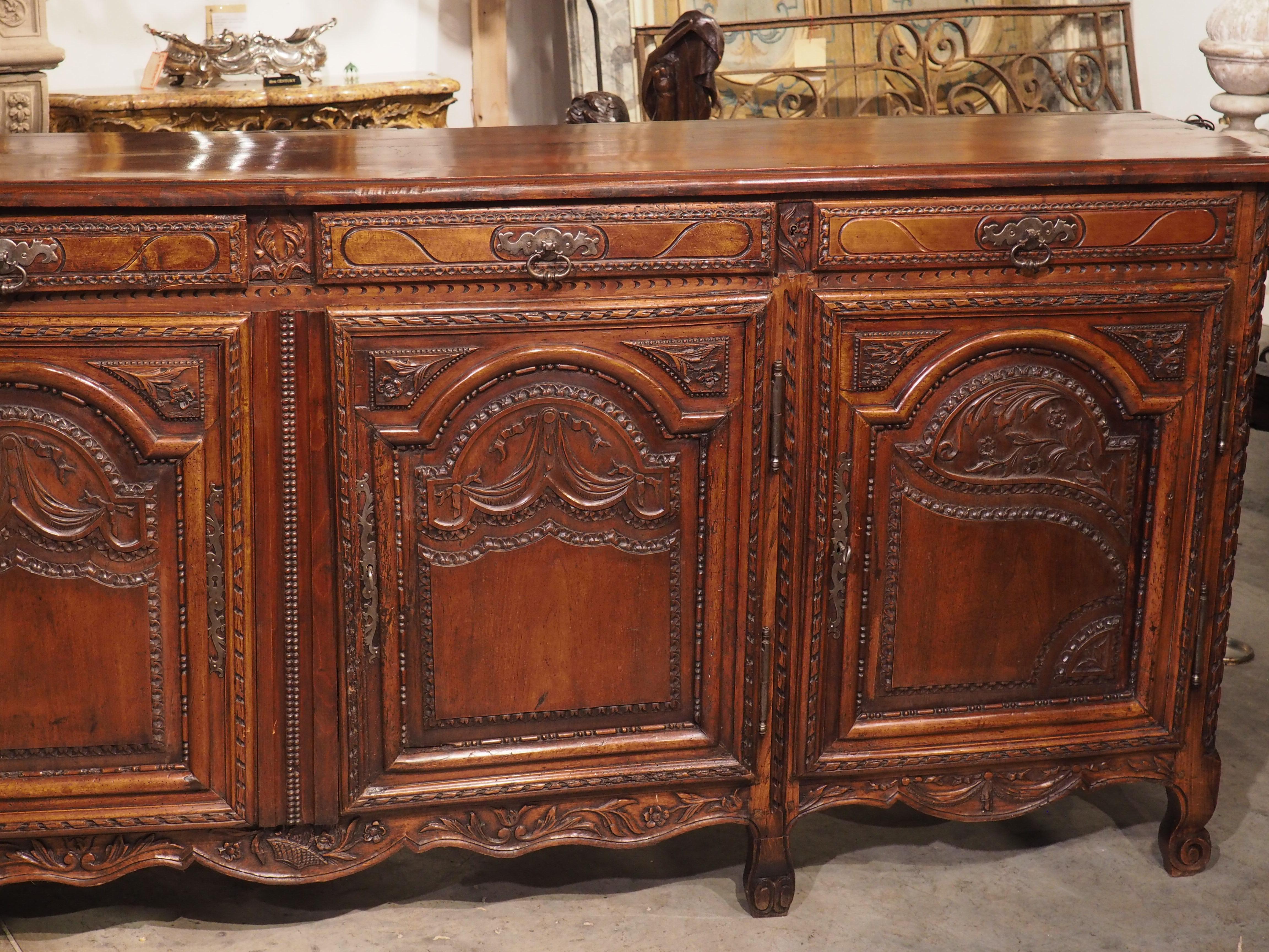 This charming antique buffet is a wonderful example of French regional furniture making in the 18th century. Known as an enfilade because of it’s multiple doors, these types of buffets were used in dining rooms in French country homes for hundreds