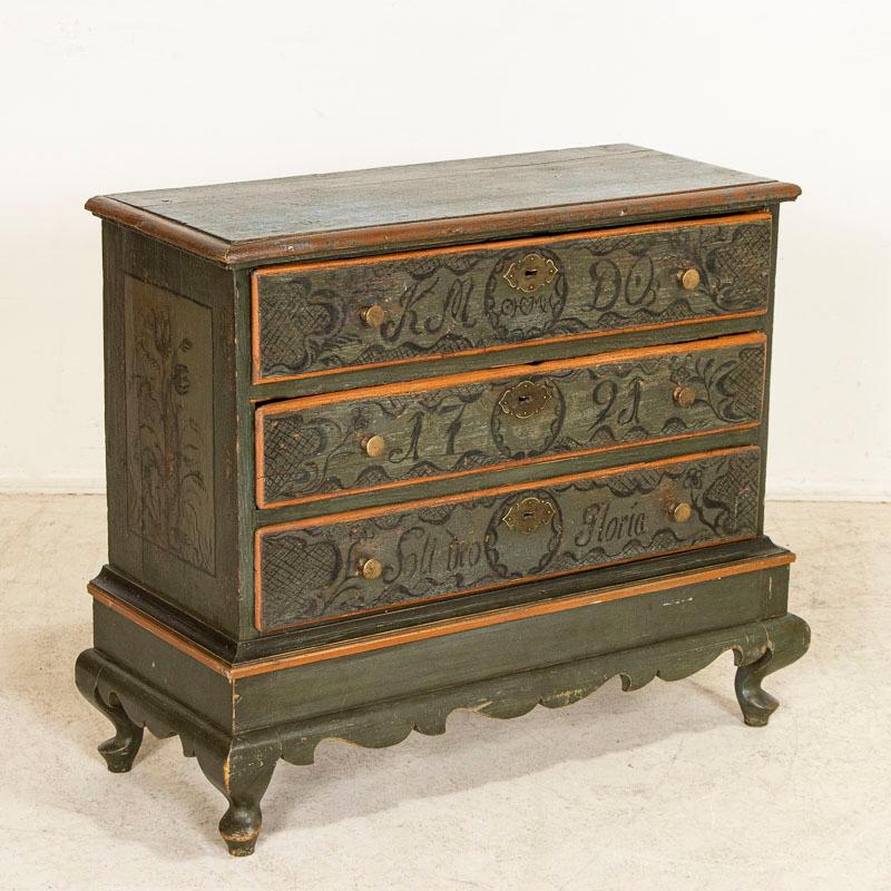 This lovely chest of drawers has multiple elements which combine to create an exceptional piece. The original green (and blue) painted finish has elaborate flourishes in the monograms, date of 1791, and highly decorated drawers which are trimmed in