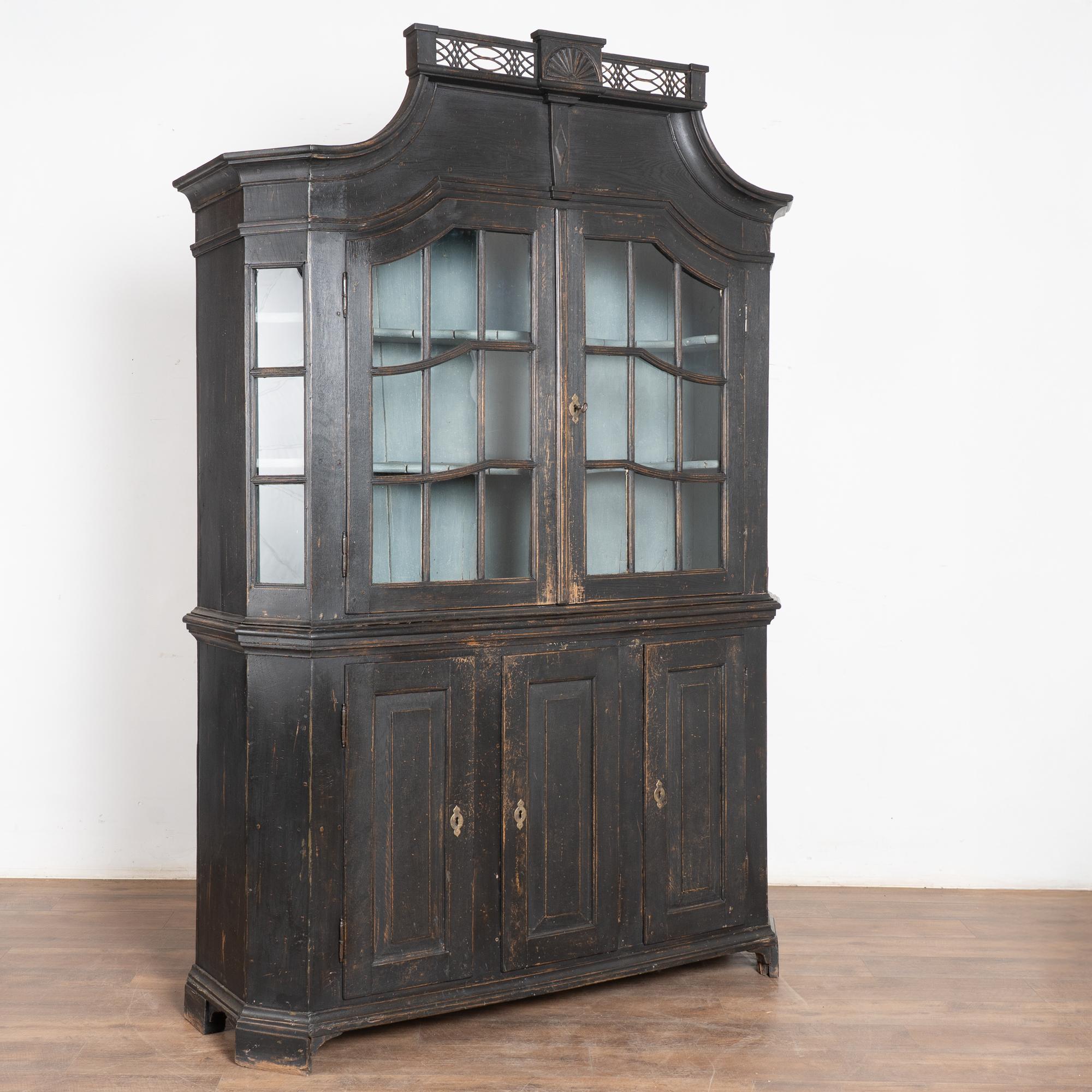 Questa vetrina in rovere danese può essere utilizzata come vetrina o libreria. Le ante superiori in vetro e i lati inclinati consentono di esporre in modo delizioso qualsiasi collezione contenuta all'interno.
La nuova finitura verniciata di nero,