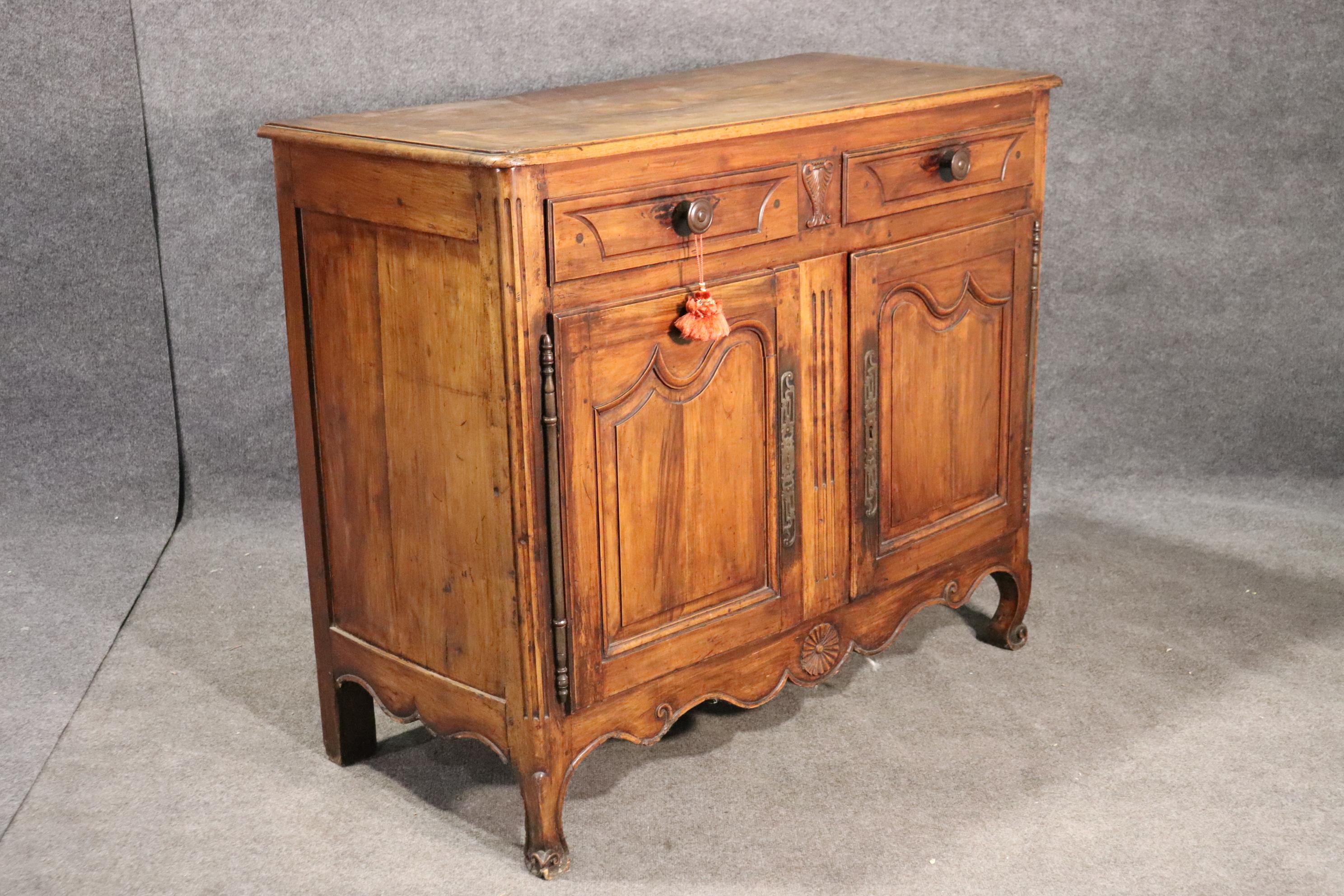 This is a beautiful and very pure late 1780s era French country buffet. The buffet measures 51 wide x 42 tall x 23 deep.