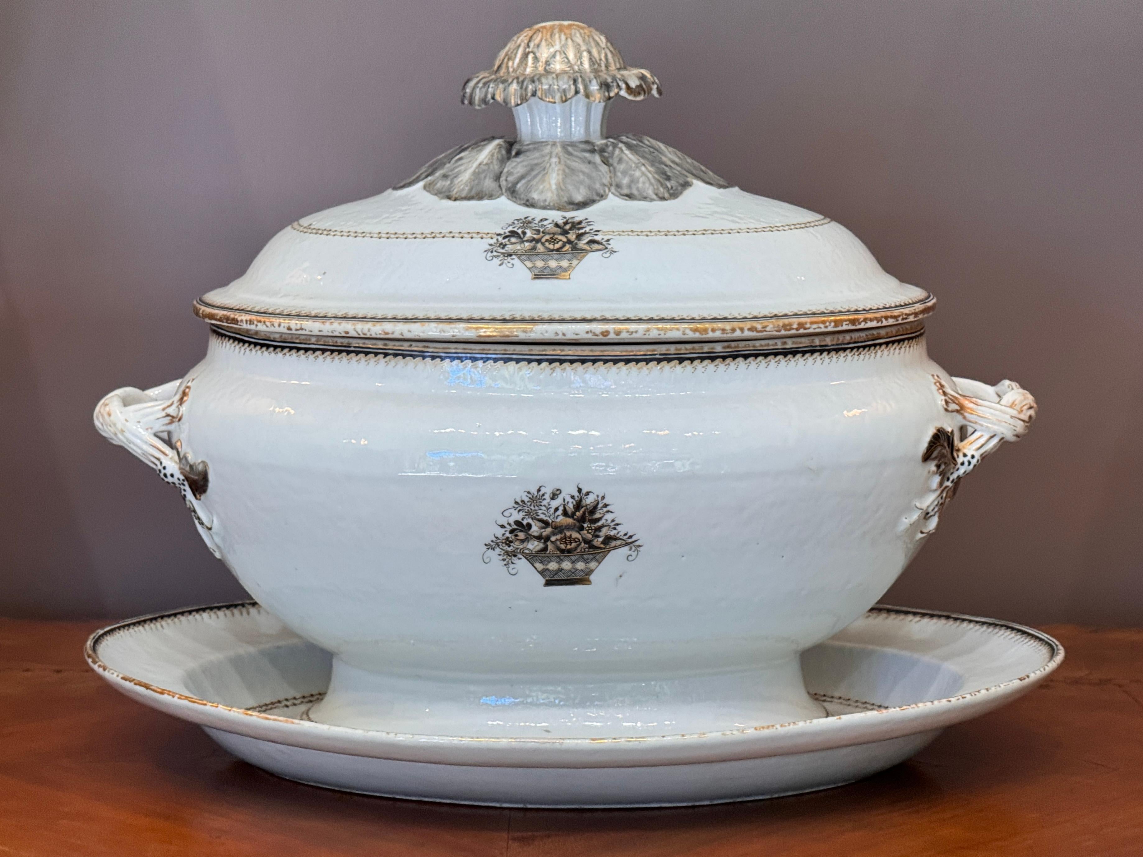 An exceptional Late 18th Century Chinese export porcelain soup tureen with its original under platter, both decorated with gilt floral borders and central baskets of flowers in sepia enamel. The tureen features twisted rope handles and a finely