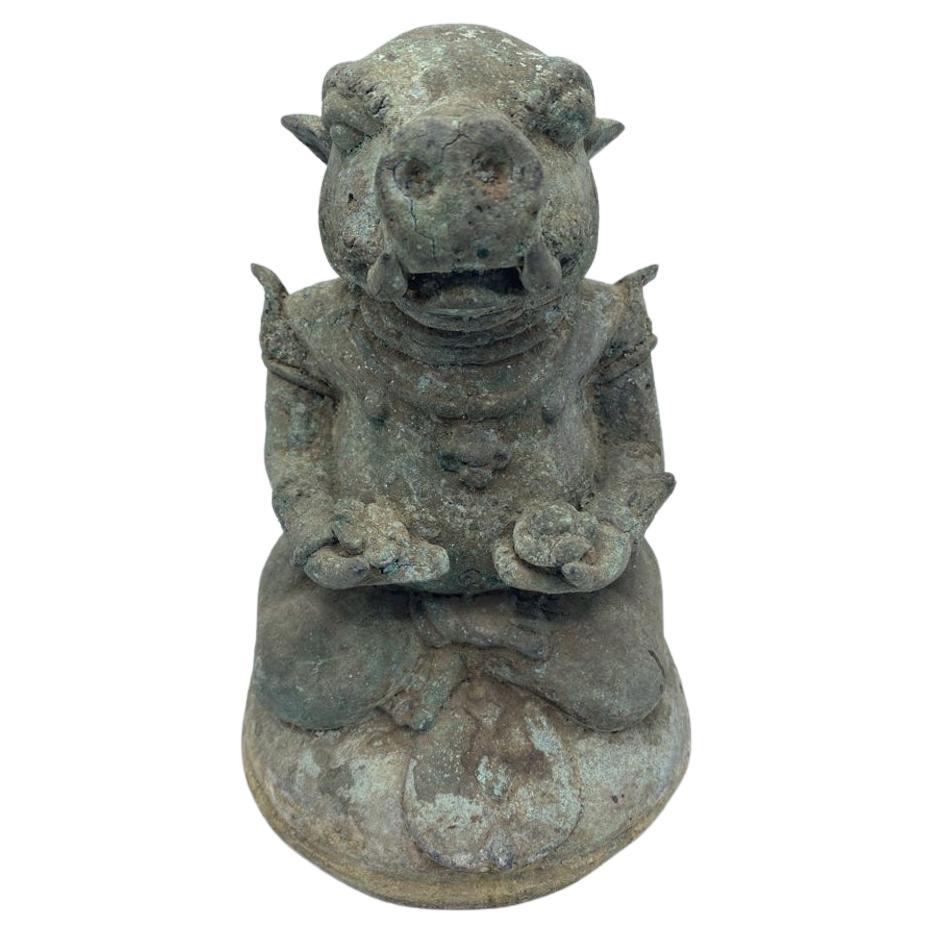 Late 18th Century Chinese Patinated Bronze Figure of Zodiac Boar
Cast as a seated boar, wearing arm bands and holding a flower in each hand with a textured loincloth, seated on a domed base. Covered in a heavy green patination. China, late 18th