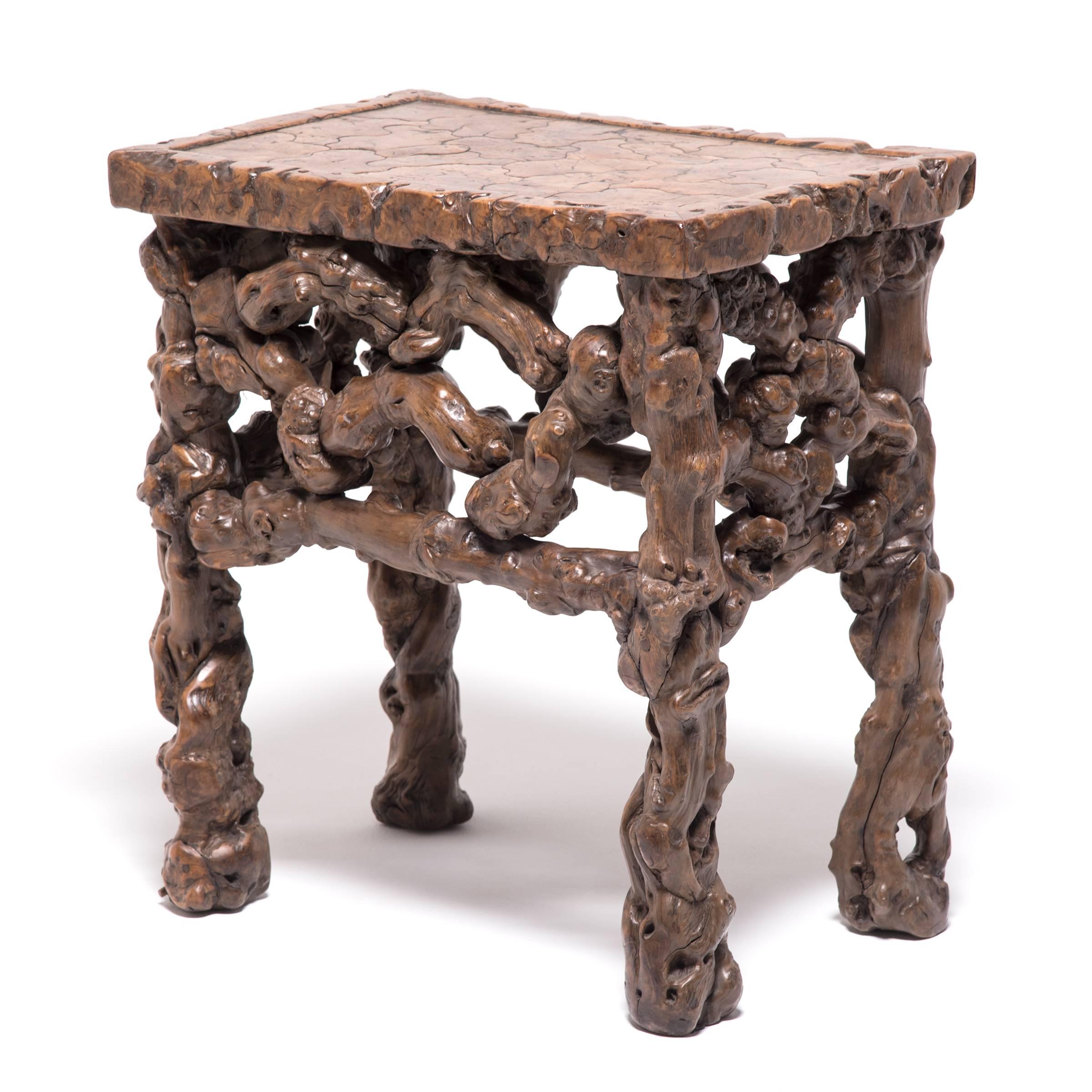 This rare, natural form root wood side table has a pierced ornate apron and marquetry-styled top that creates a beautiful, interlocking pattern. Naturally contorted wood has been appreciated in China for millennia. The organic forms appealed to