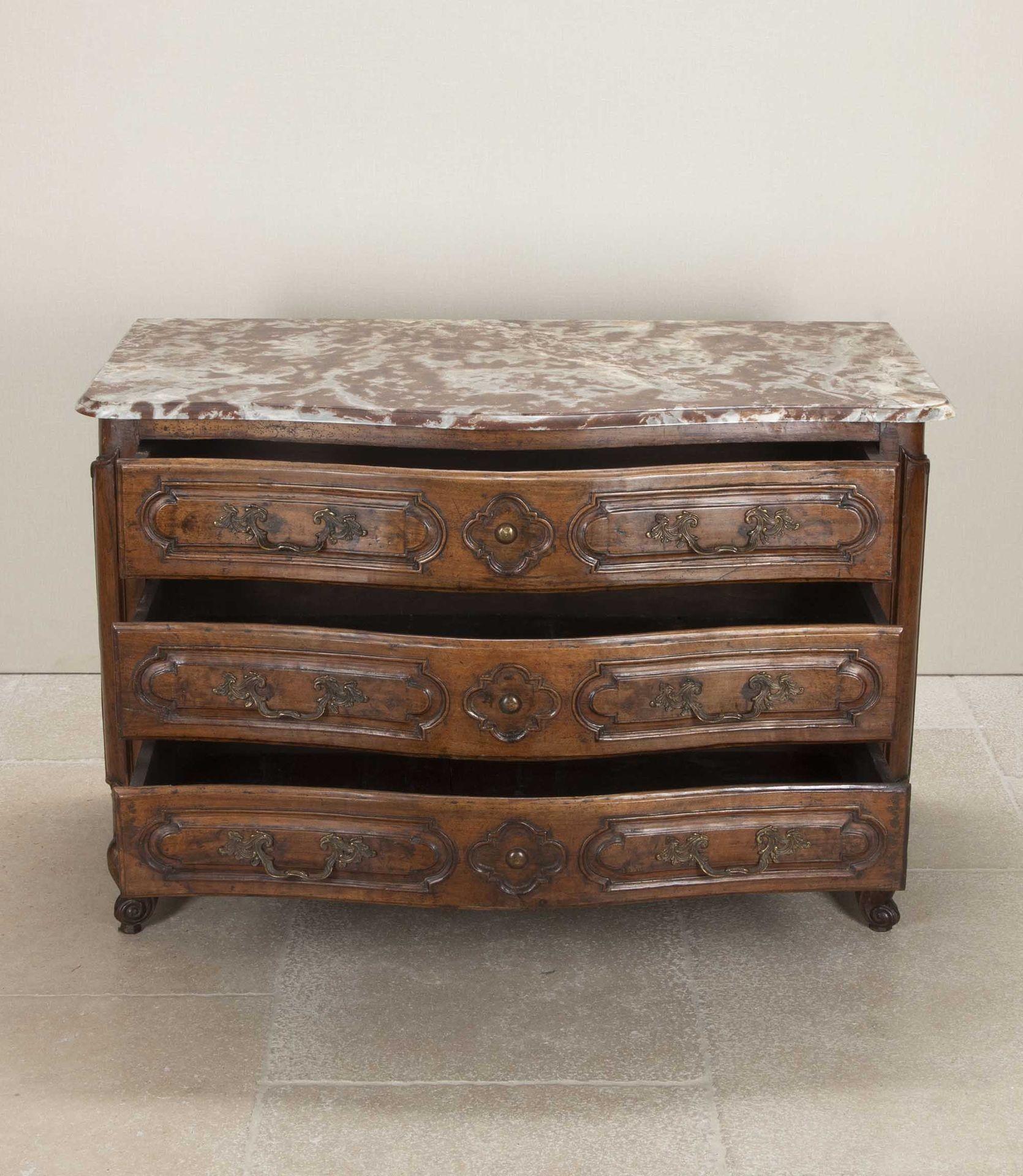 Late 18th Century Serpentine commode from the Rhône Valley, France. Three long drawers retain their original hardware. The rouge marble top is a later, 19th Century, replacement. Drawer linings and backs are replaced.