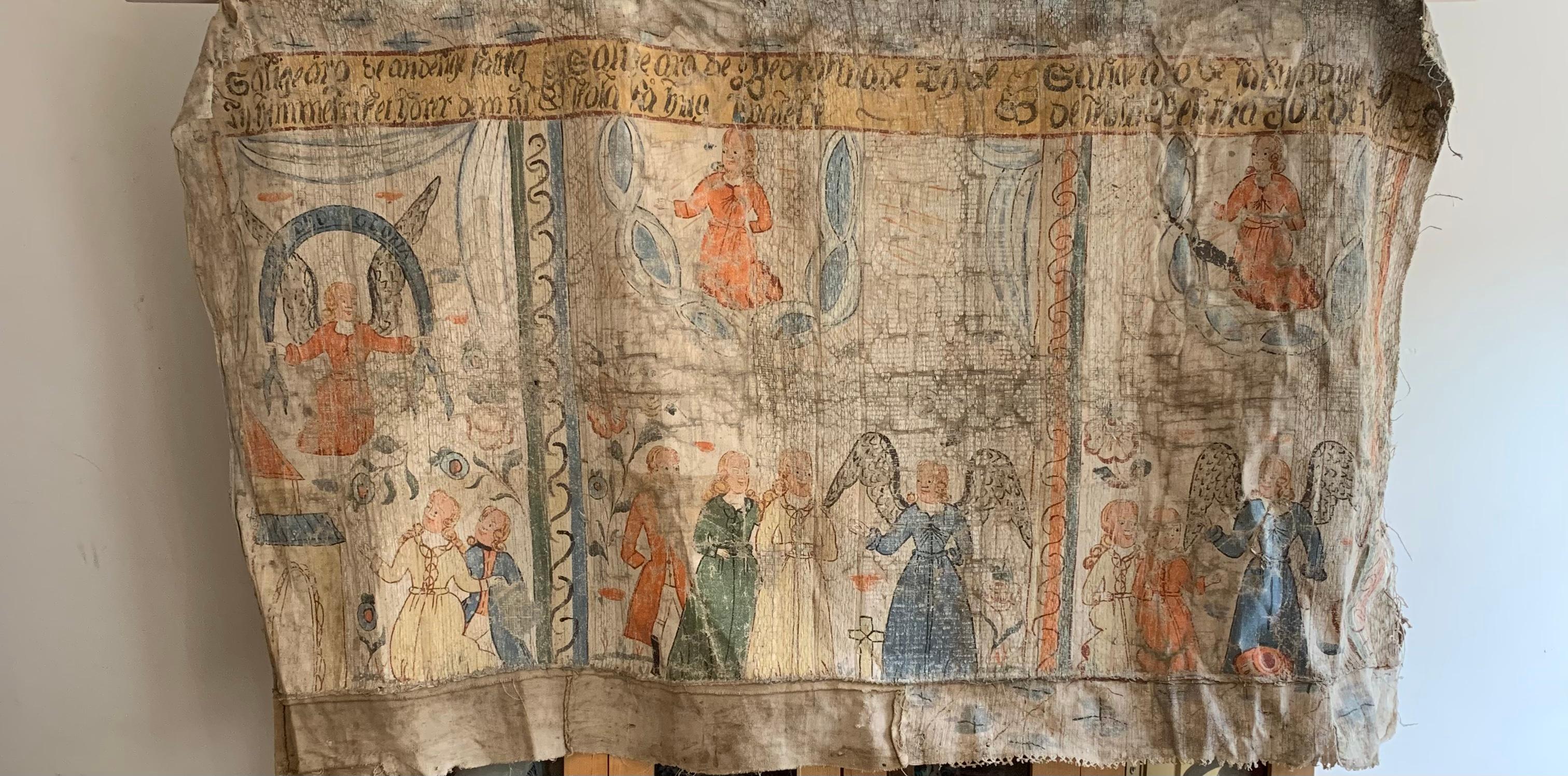 Appendiabiti da parete dipinto di arte popolare svedese di grandi dimensioni, che potrebbe provenire da una chiesa.
Dipinto su tela con pigmenti naturali, raffigura temi biblici ingenui che sono la tradizione di questi pendagli popolari, che