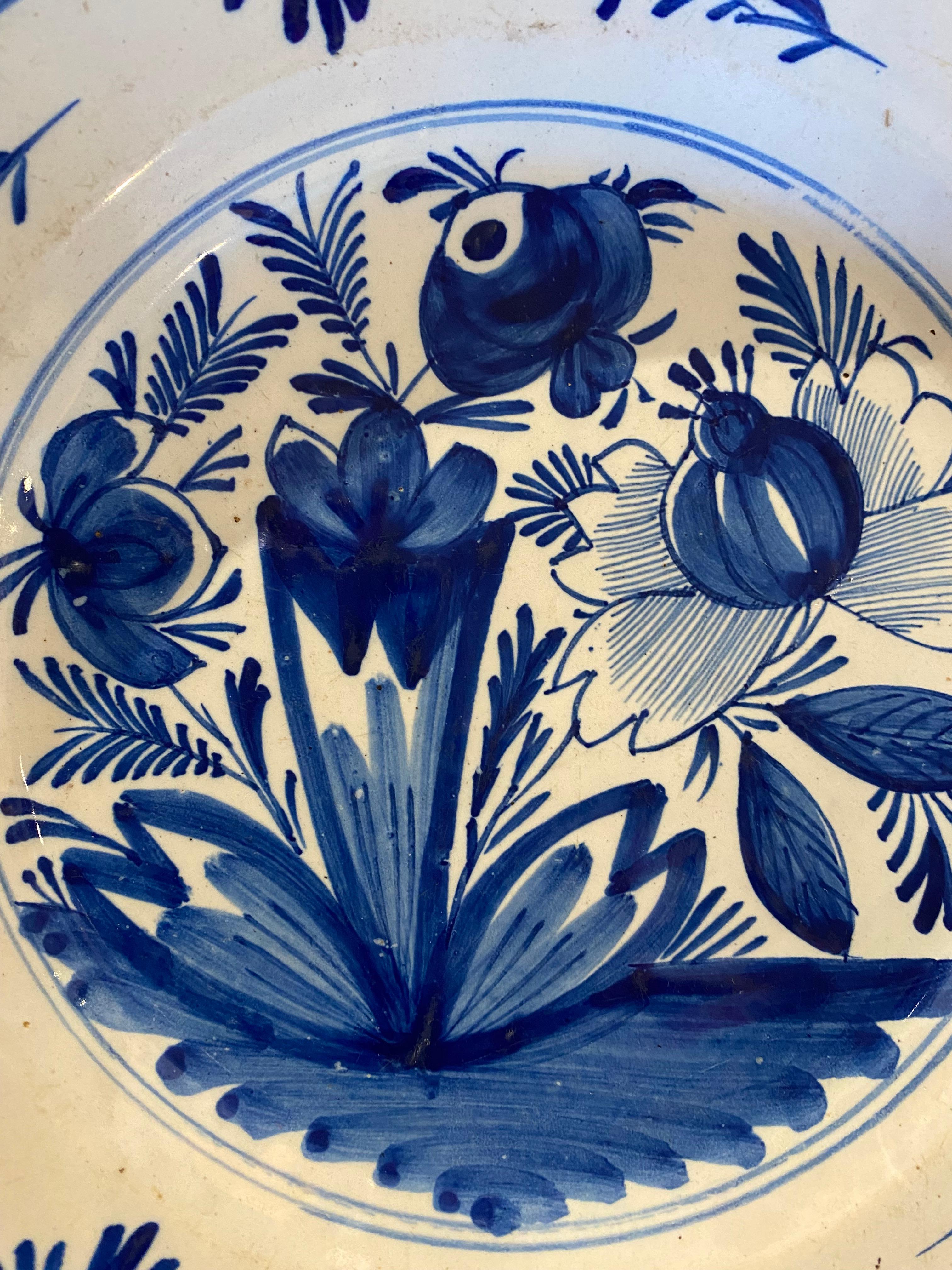 This Delft plate present blue dots on the border and flowers, leaves,all vegetal decor in the center 
The cobalt blue marking the identity of the Delft faience in different shades .
the Delft faience appears in the 17th century in the dutch town