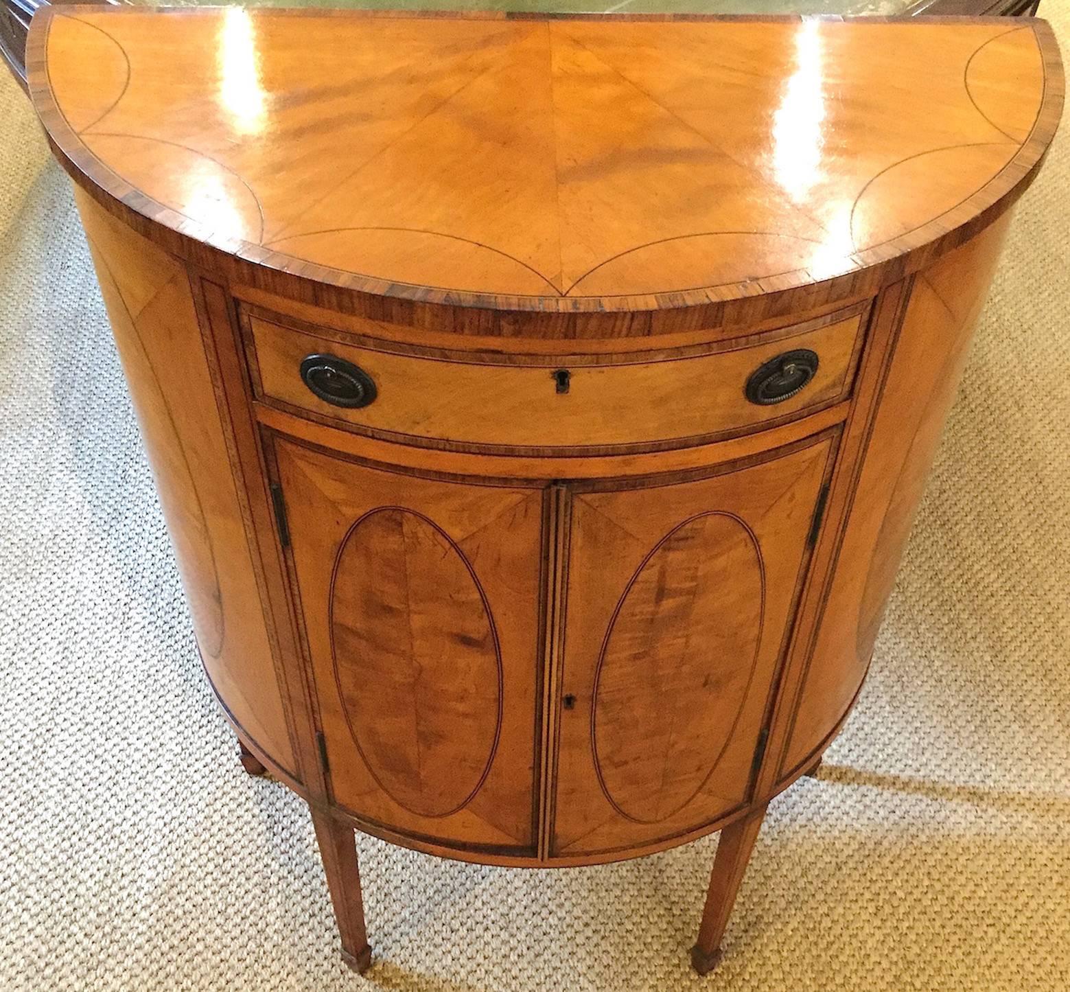 18th century demilune satinwood commode of small proportions, in the manner of Mayhew & Ince

A superb Sheraton period late 18th century semi-ovoid satinwood commode of small proportions, in the manner of Mayhew & Ince, circa 1780-1790.
The top