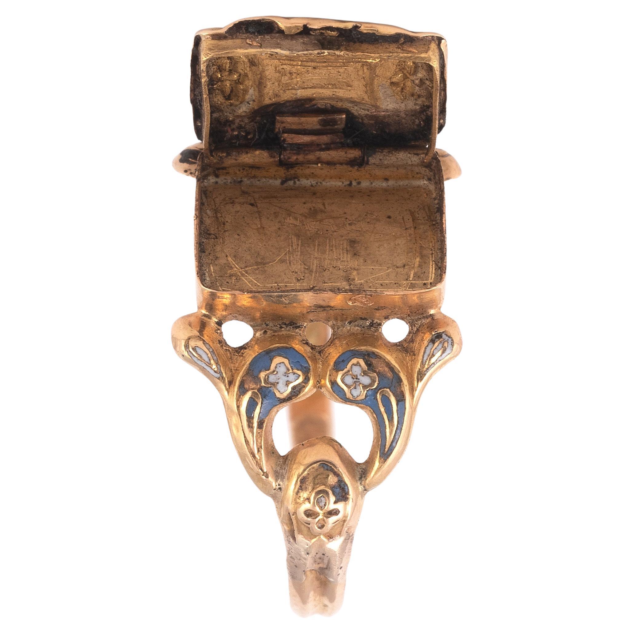 Ring composed of a plant design decorated with white, blue and black enamel with a flap compartment. The frame with pierced decoration is in 18K yellow gold.
Size : 7 1/4
Gross weight: 1.42 gr.

There is a similar ring in the Alice and Louis Koch