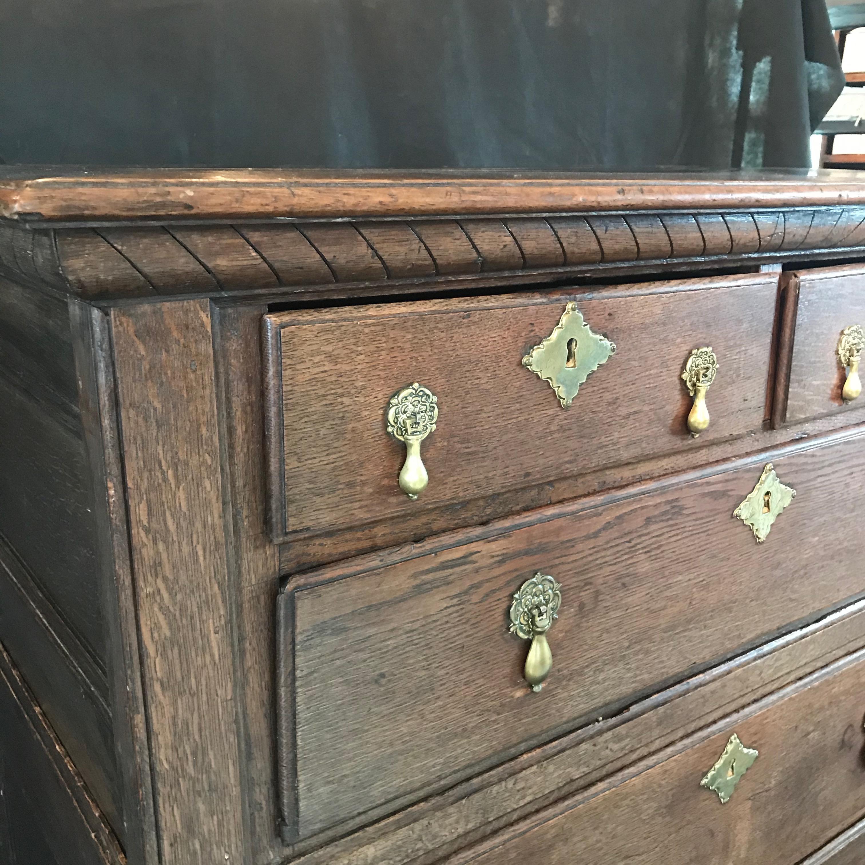 Super early antique Charles II English oak chest of drawers having two small drawers at the top and 3 large drawers underneath. Brass hardware is beautiful and all drawers work smoothly.
#4953

 H split 25”.
  