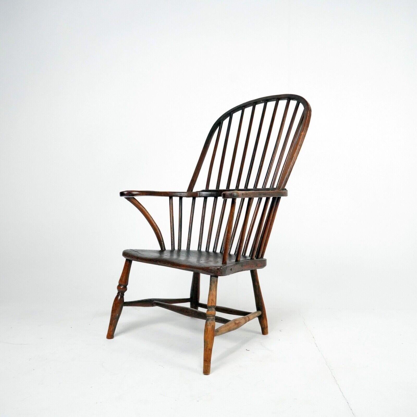 A Late 18th century elm and ash bow-back Windsor chair. 
Real individual character to this primitive looking example, each part unique and part of the chairs history. 
Lovely slab seat, nice old repair to the arm bow.
A low chair that would sit