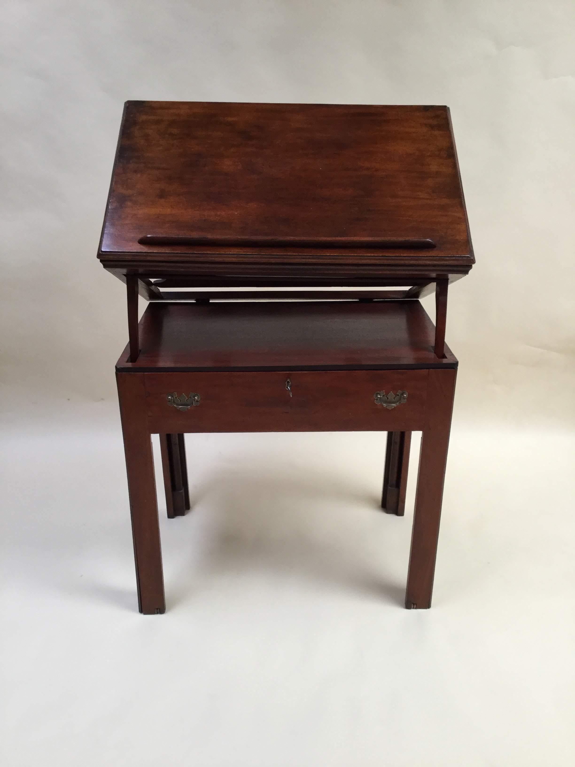 Rectangular top with molded border, raising on a easel support with a book rest at the front. The front pulling out to form a sliding writing surface, enclosing fitted compartments and a lateral sliding ink compartment, two secret drawers at each