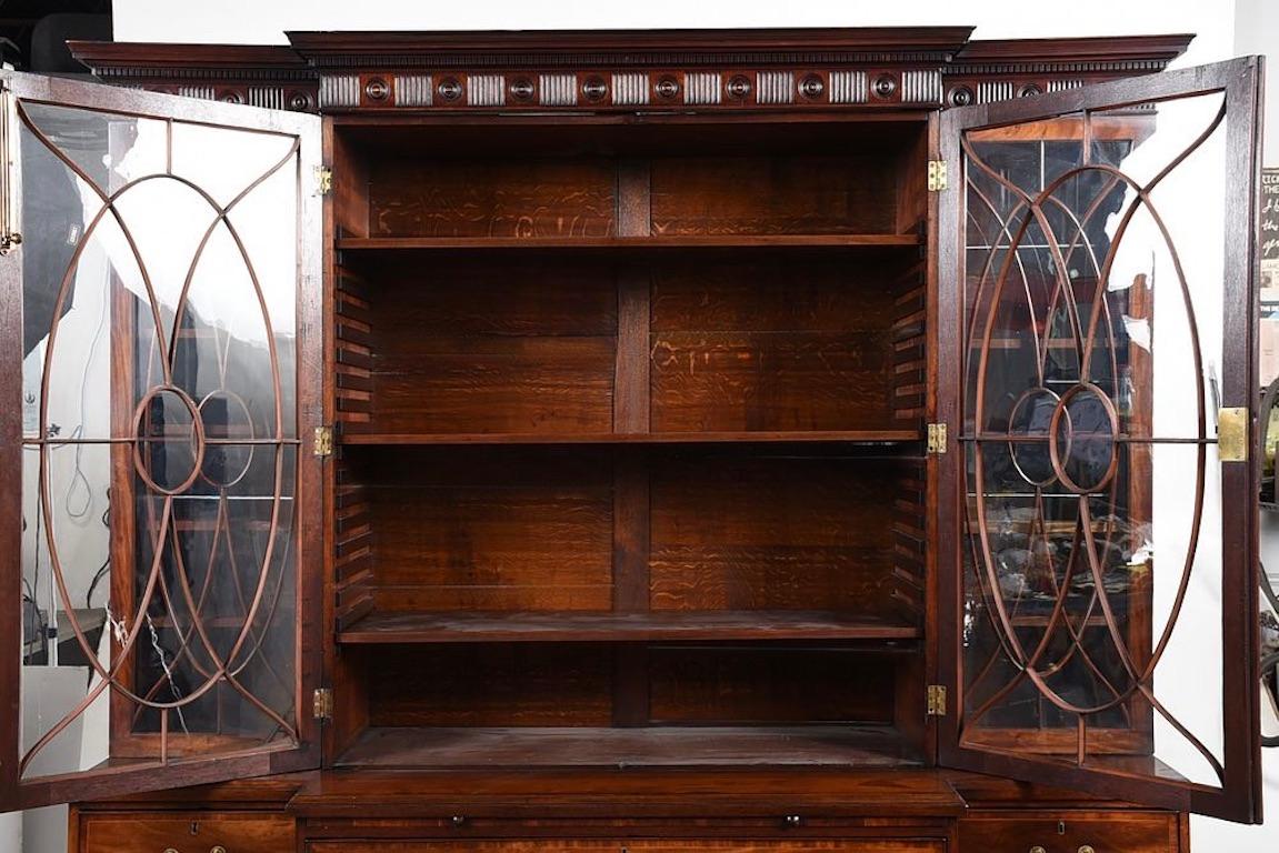 Period George III Chippendale Breakfront Bookcase. Late 18th Century. Disassembles for shipping. Fluted cornice with alternating rosettes. Beautiful mahogany figuring and great patina. Old glass. Drawers slide well. Piece of substantial