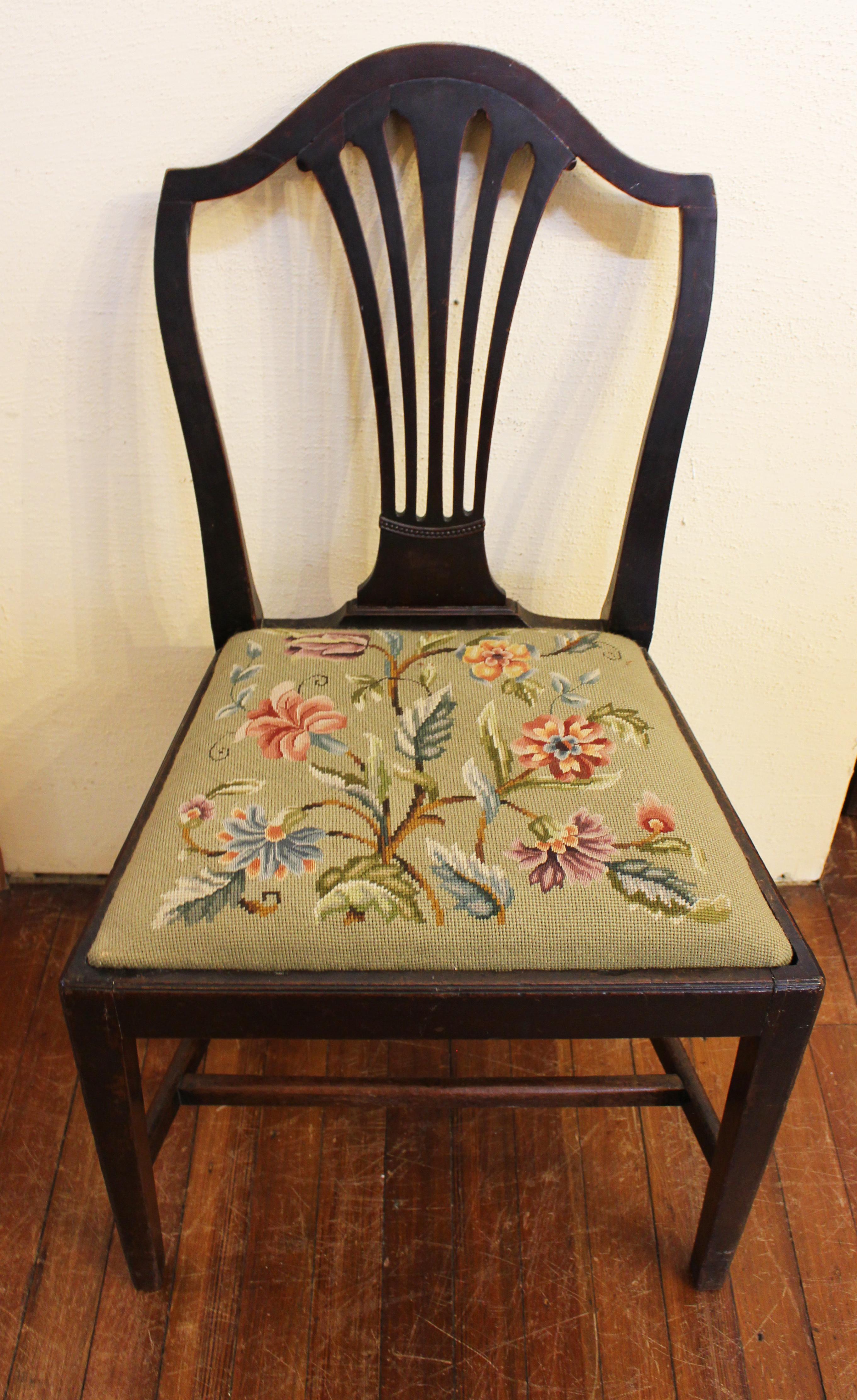 Late 18th century side chair. English, George III. Well molded, shaped back with pierced backsplat. Blackened through patination mahogany. Needlepoint slip seat. Straight, tapered legs & stretchers. 36 1/2