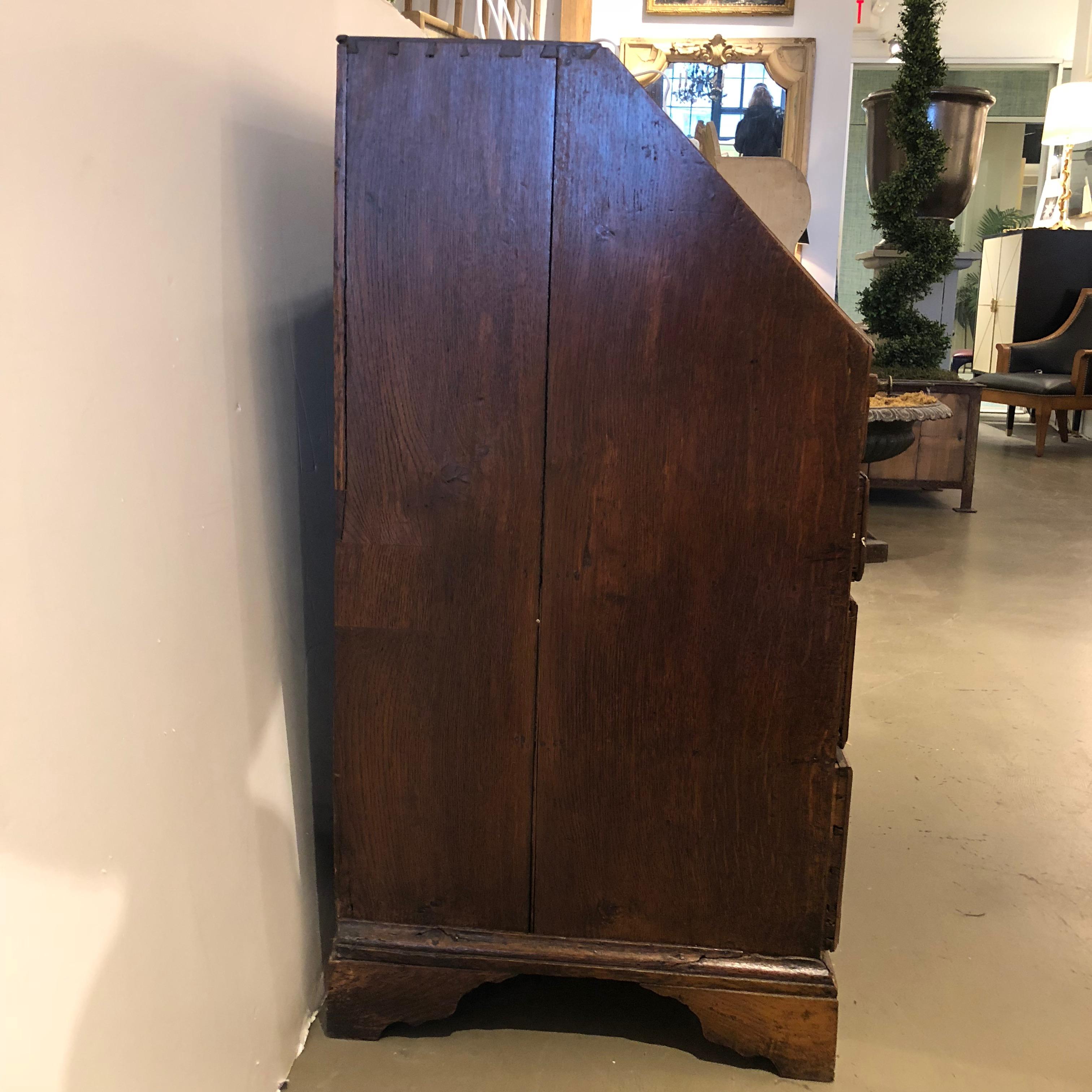 Late 18 century English oak slant front desk with banded inlay in good order. Two - side by side upper small drawers and two - full width lower drawers. Original wood pulls replaced with appropriate antique brasses. Many hidden interior compartments