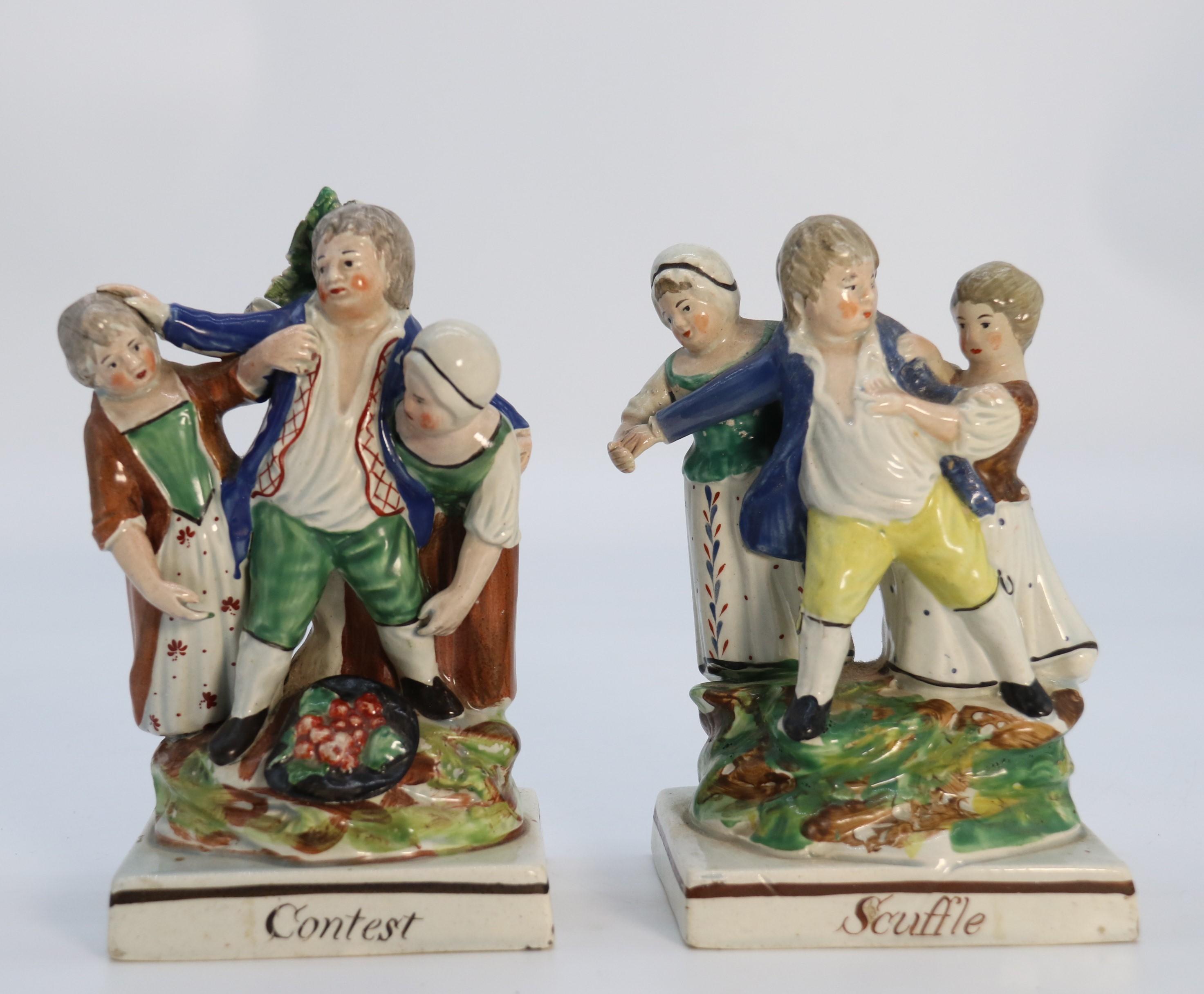 A rare pair of late 18th century English Staffordshire figure groups of two young men about to have a scuffle.

This rare pair of early English Staffordshire groups each portray a young man about to enter a scuffle. Both he and his opponent are