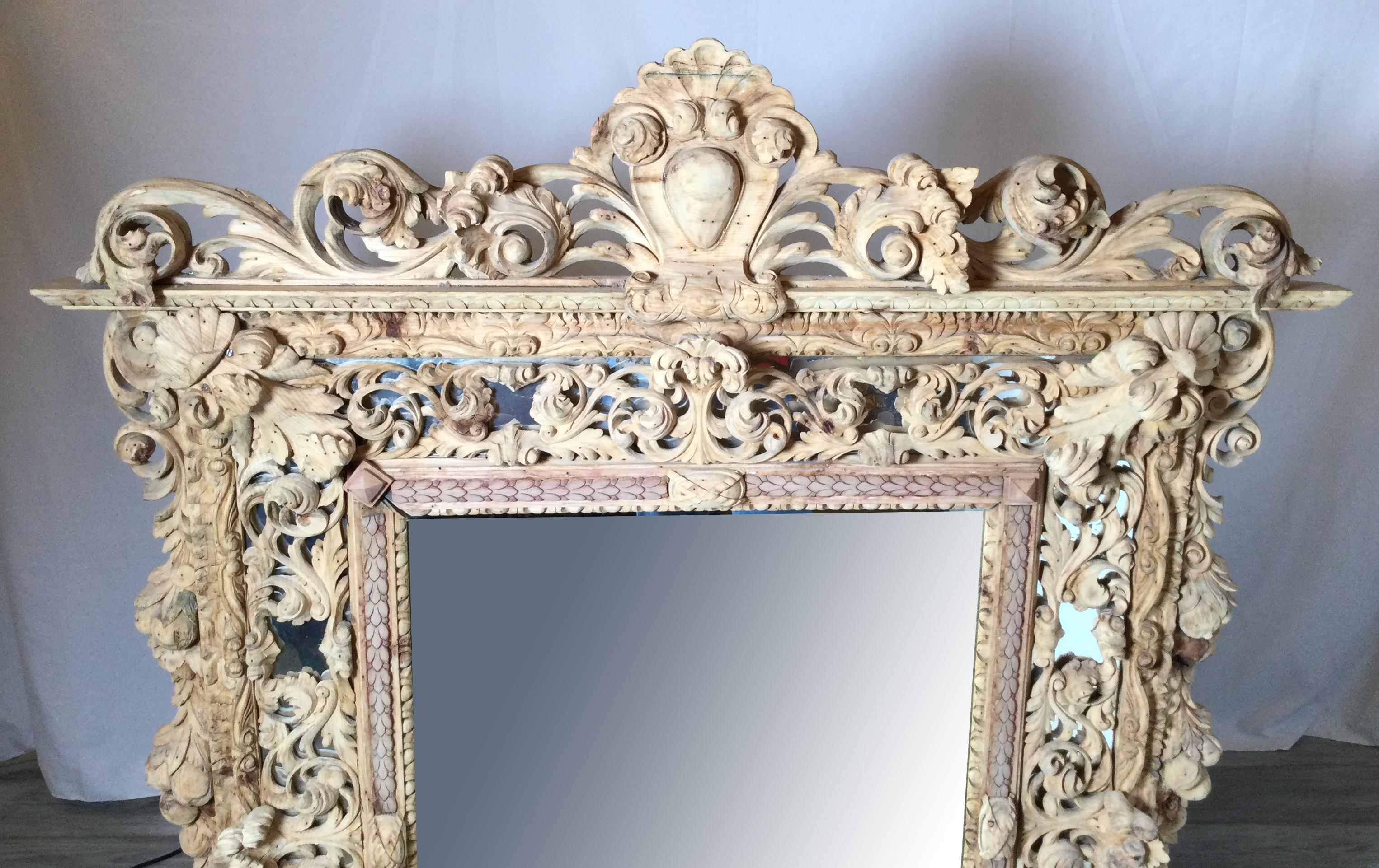 Late 18th century exceptionally hand carved wooden Venetian mirror, probably made in Italy and was gold gilded many years ago. Finish has been stripped and removed at some point.
Has a very great architectural look that is both rare and