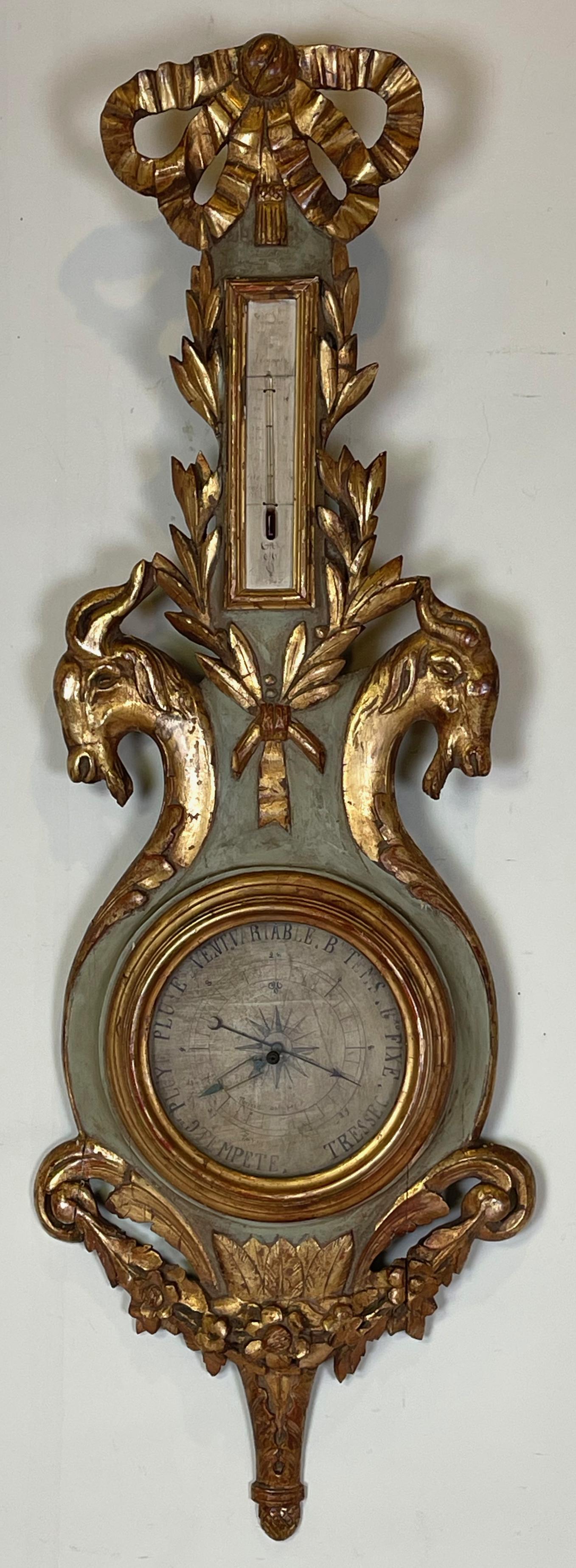 An elegantly carved painted and gilt decorated late 18th C., Louis XVI, French barometer with original thermometer.