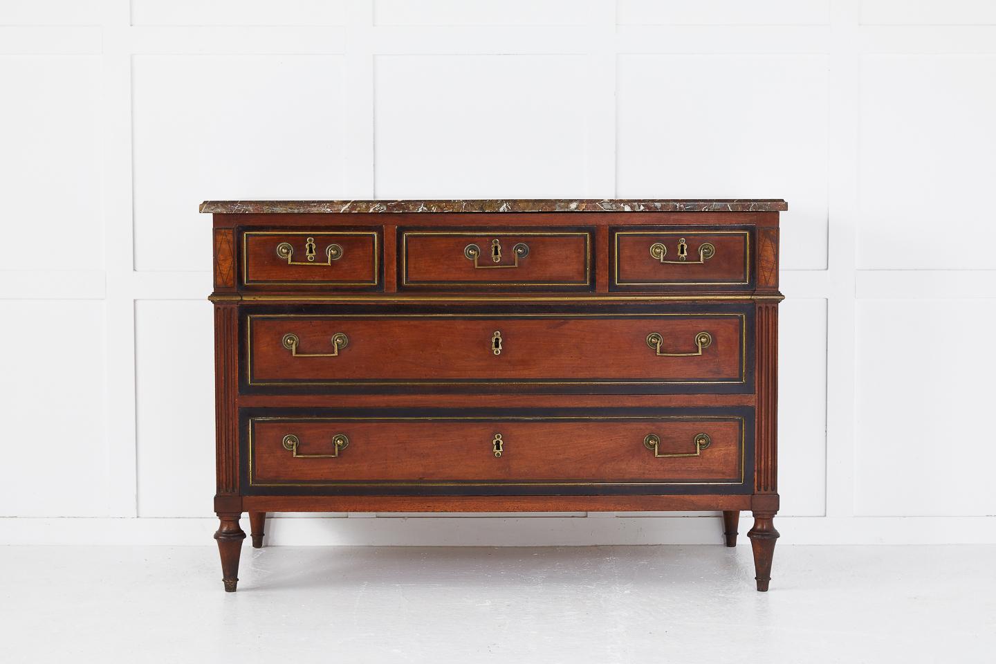 Late 18th-early 19th century French cherrywood commode with ebonized banding and brass mouldings with original marble top.