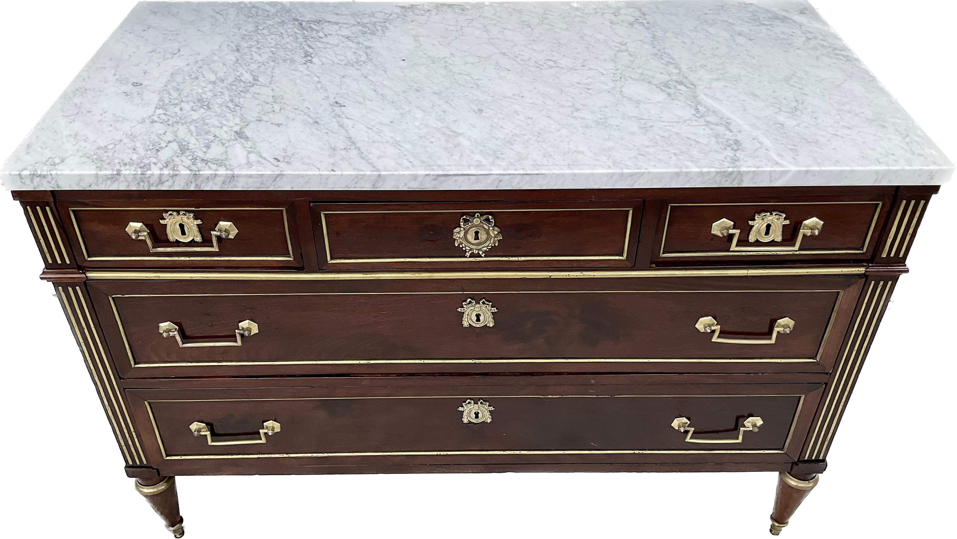 Late 18th century French Directoire or Louis XVI Chest. Three drawers across top, two large drawers under, for a total of five drawers.        
inset brass fluted columns ,the sides of case and drawers with conforming brass moldings , raised on
