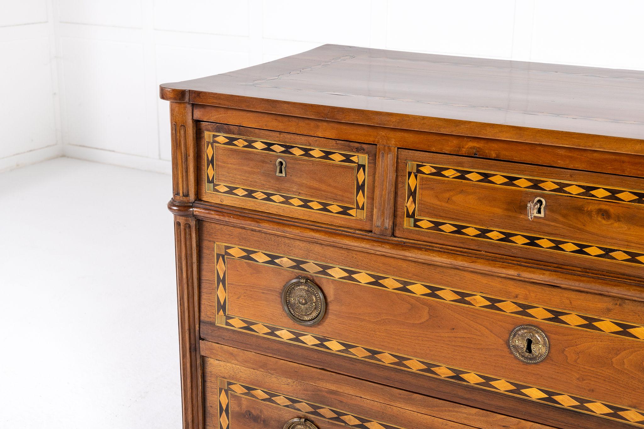 A Fine Late 18th Century French Inlaid Walnut Commode or Large Chest of Drawers with Secret Drawer.

Of high Louis XVI neoclassical form, this commode features a versatile combination of three small upper drawers, and one concealed secret drawer
