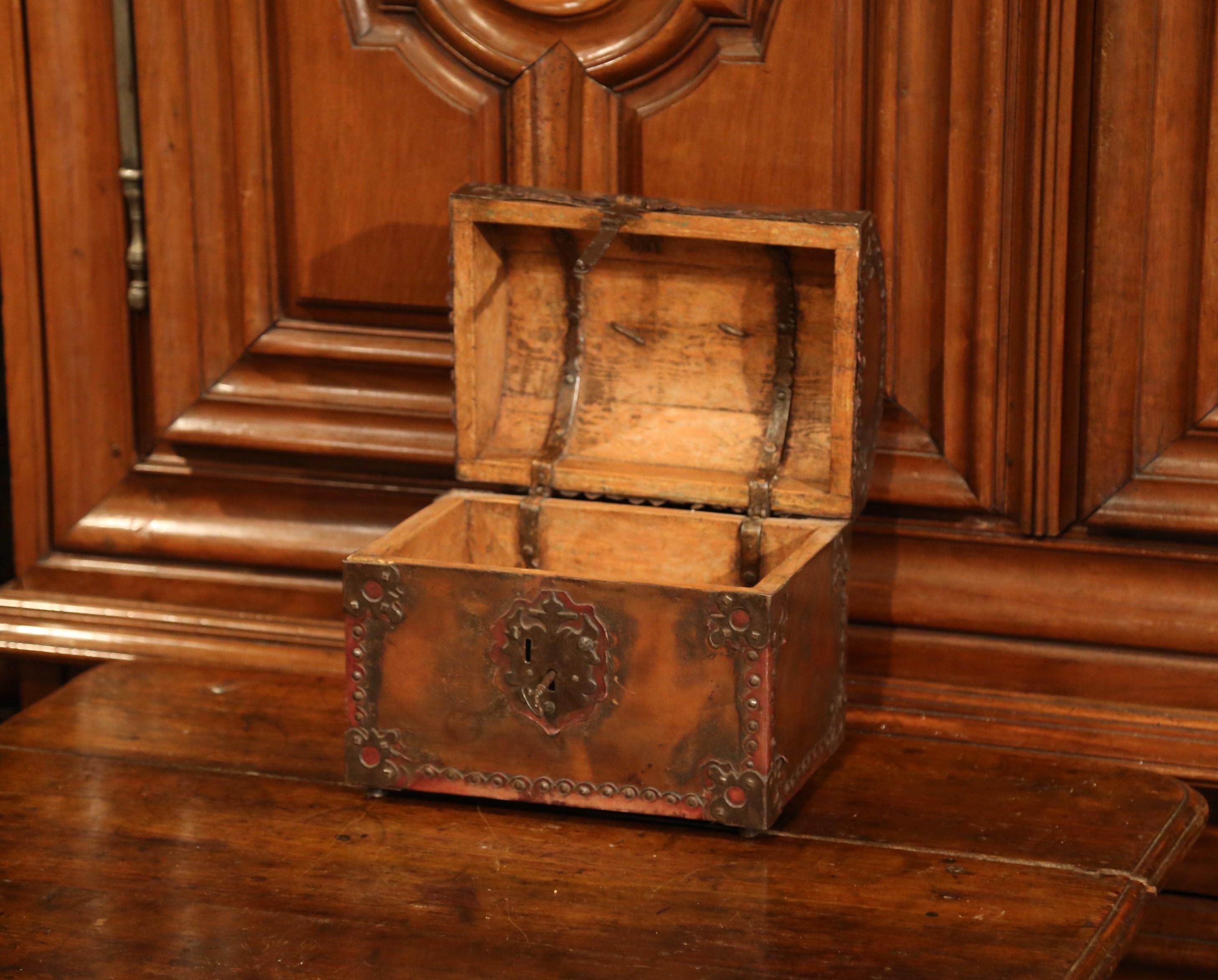 This beautifully crafted, antique trunk was crafted in Southern France, circa 1780. The brown leather box is shaped like a Classic storage trunk with an arched top and a rectangular front and back. The box is finished on all sides with rustic