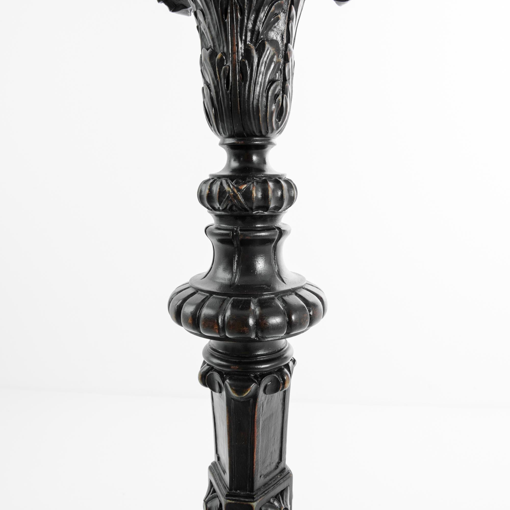 This wooden floor lamp with floral and foliage carvings was made in France, circa 1780. It features a pleasing balance of curves and angular forms, ornamented with acanthus scrolls and gadroons that hint at a neoclassical influence. Tripod legs with