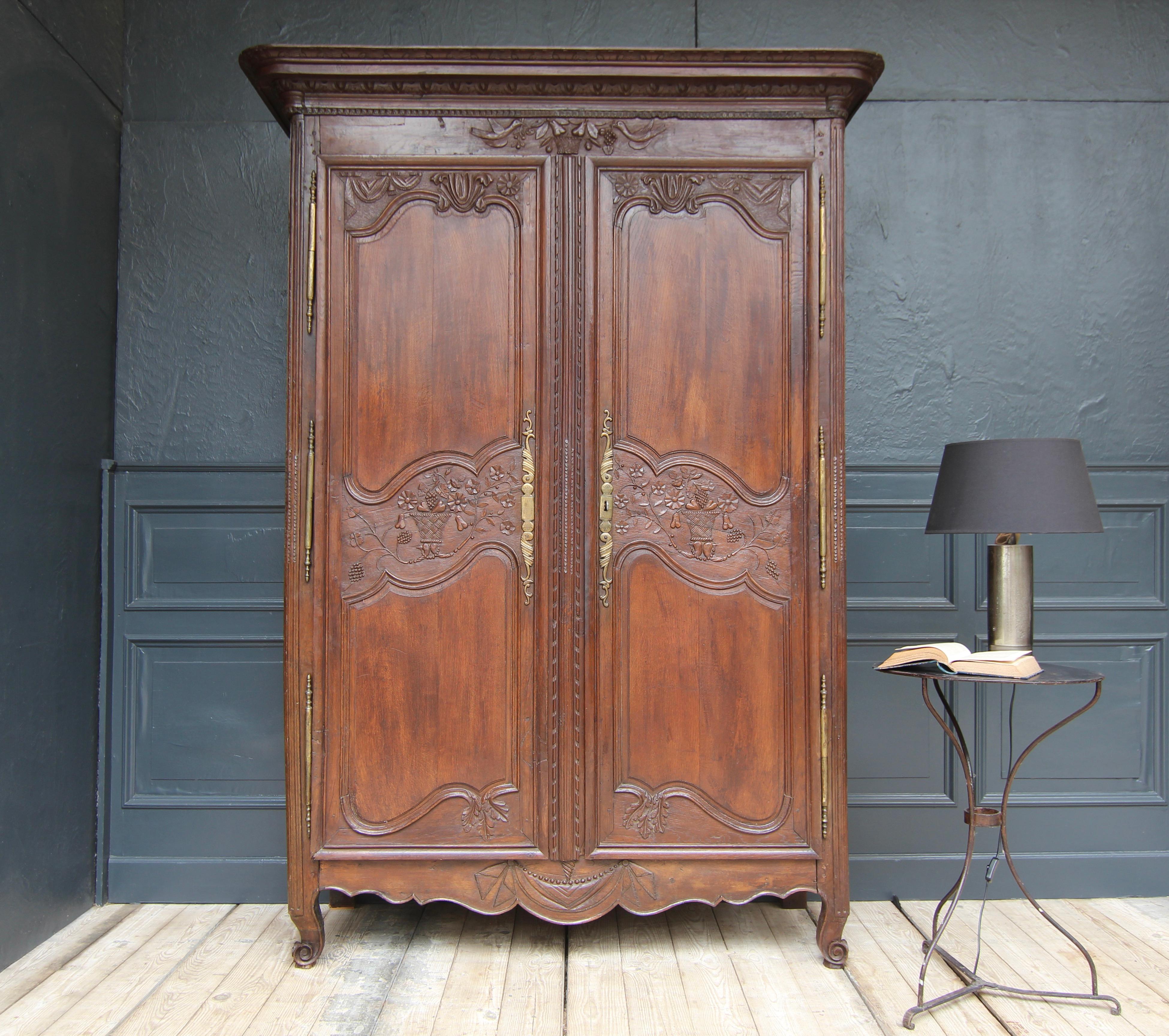 A french provincial cabinet or armoire, so-called wedding cabinet. Normandy, end of the 18th century. Solidly made in oak with beautiful carvings. 

Traditionally in the 18th century, cabinets of this type were brought into marriage as a dowry for