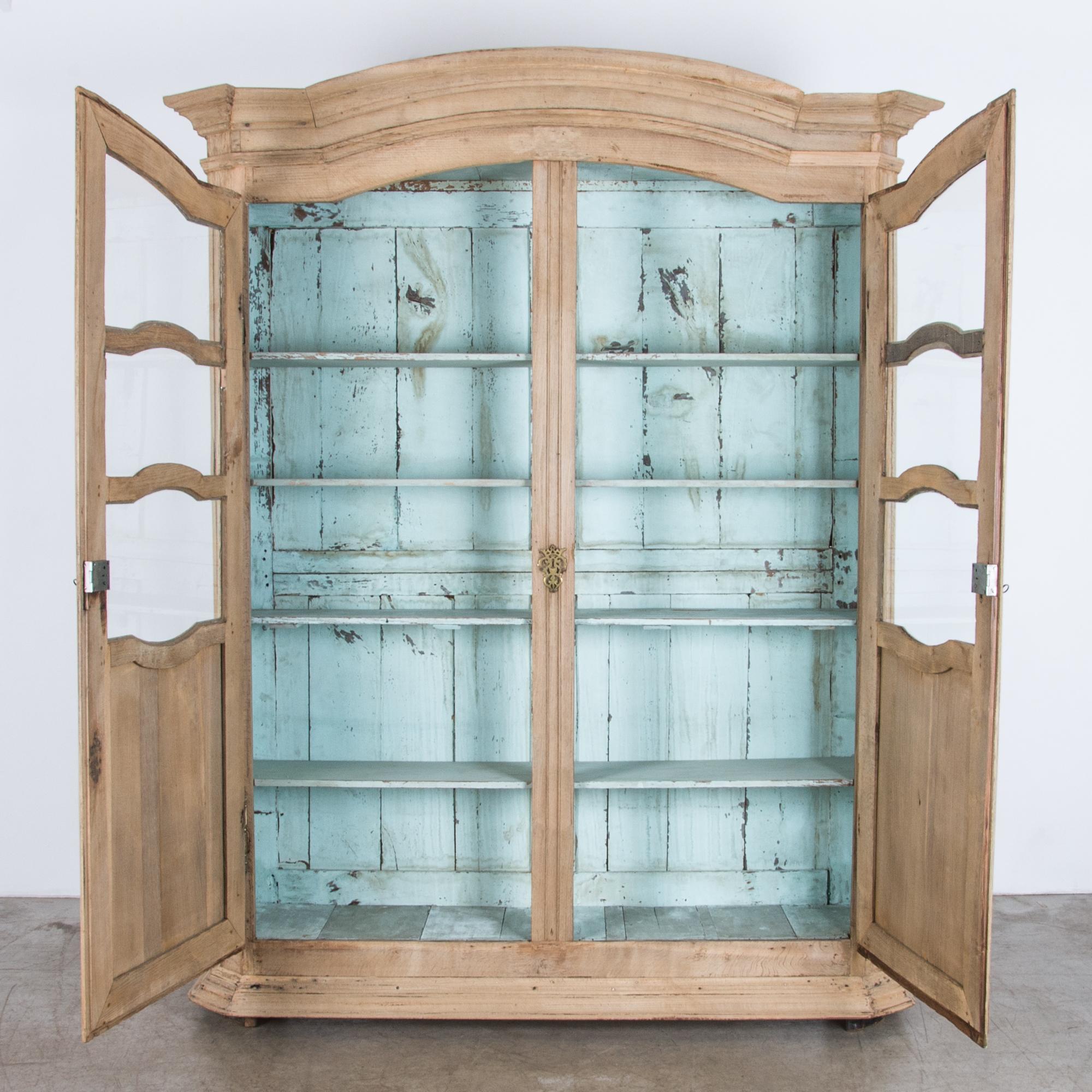 An artefact of the French countryside, in warm and light textured oak with a dramatic bright interior. Five spacious shelves give plenty of storage space, with the upper three levels revealed for display by ornate curved glass panes. Frame and panel
