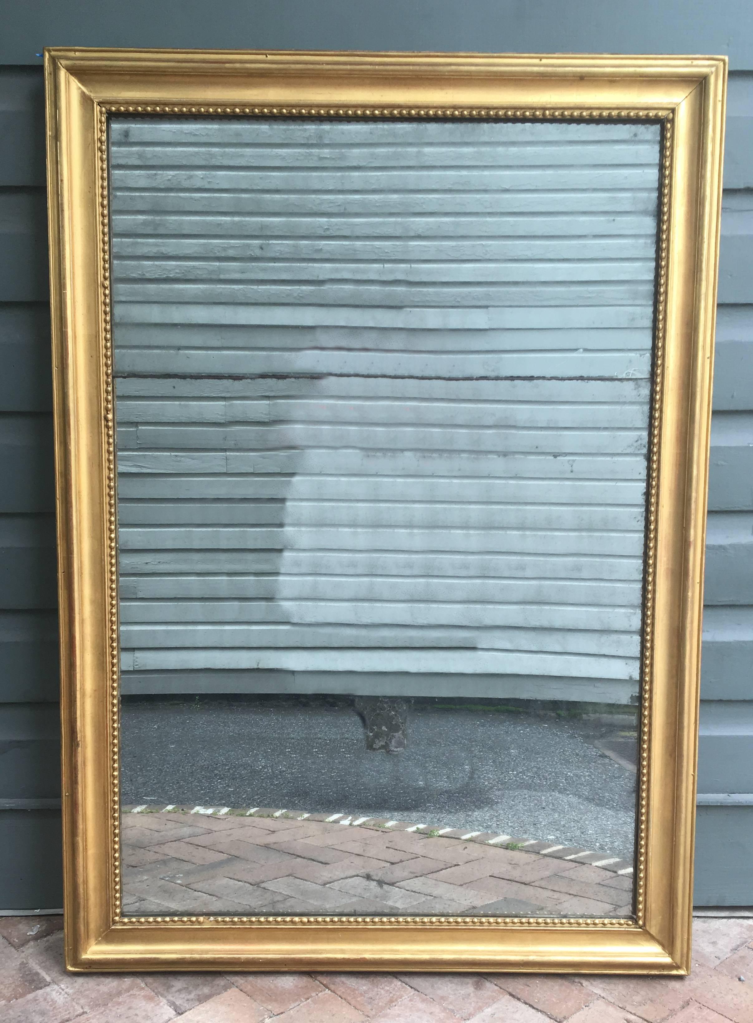 Wonderful 18th century French restoration mirror. Aging to the silver of the looking glass with original mirrors in two plates.