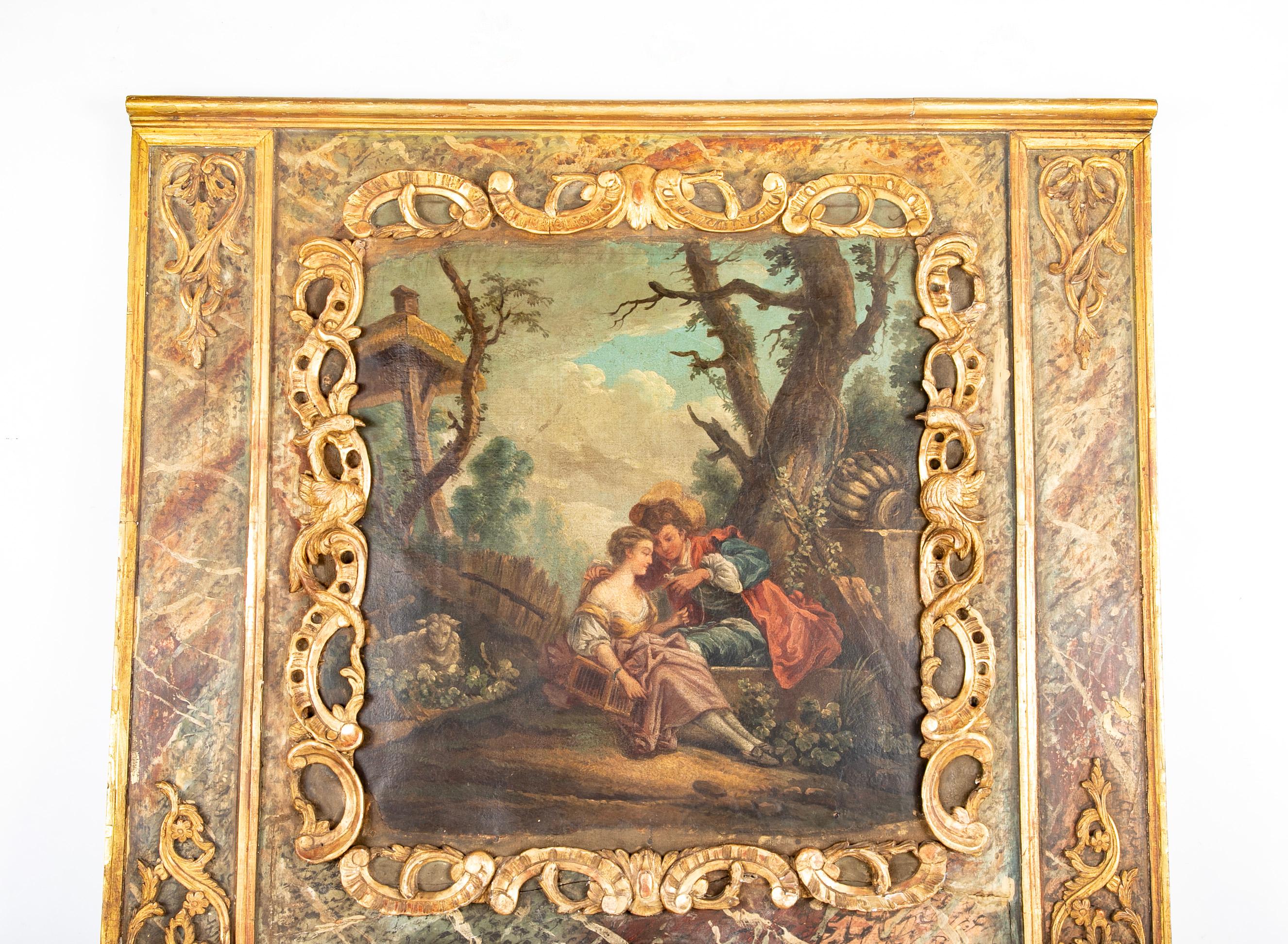 Late 18th Century French trumeau mirror with gilt carvings, rare faux marbelizing and romantic painting.