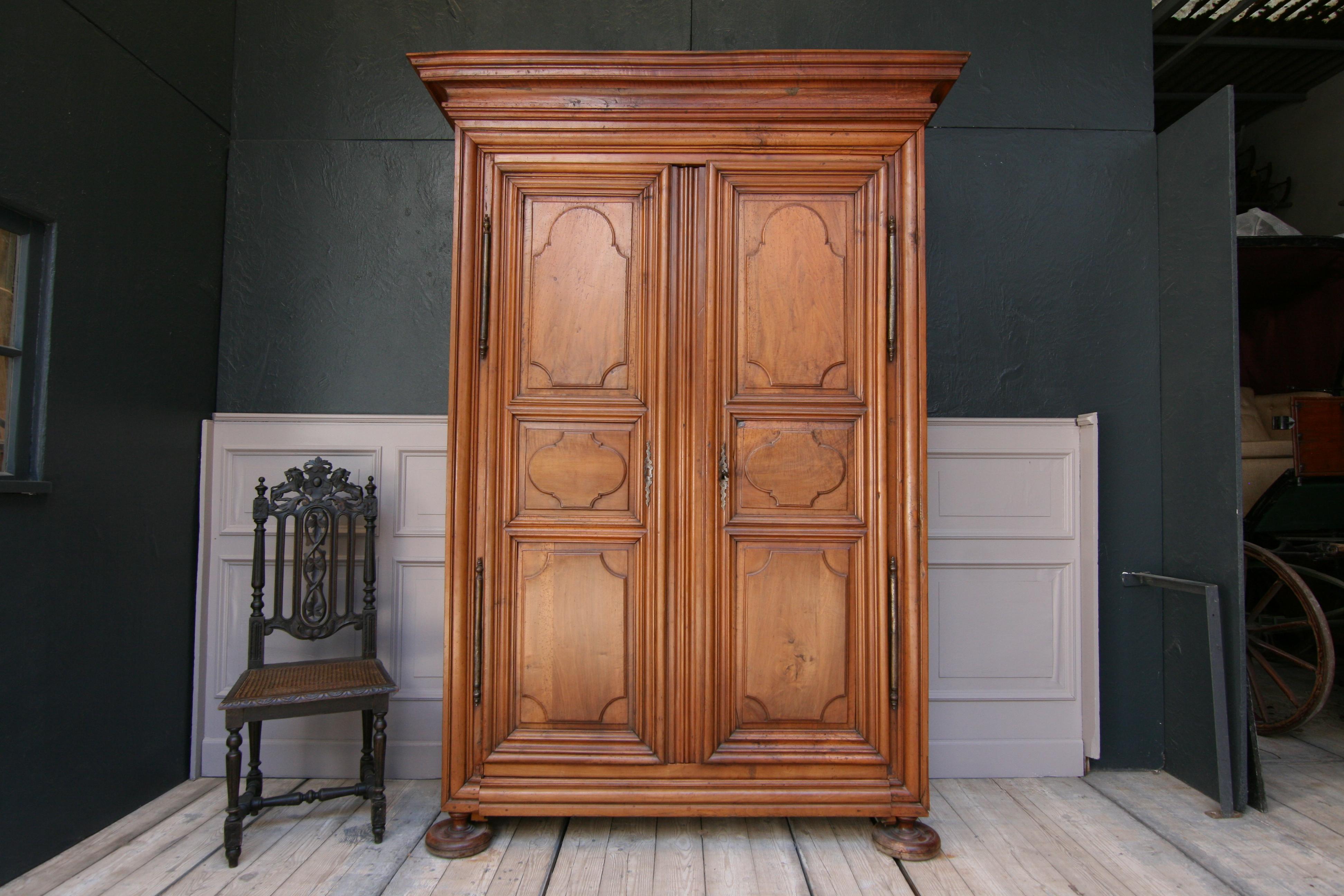 French Louis XIV cabinet from the Alsace region, circa 1780. Solid walnut and partly oak.
Large iron fittings and lock.
Completely lined in pink on the inside (but can also be easily removed).

The cabinet can be completely dismantled with wooden