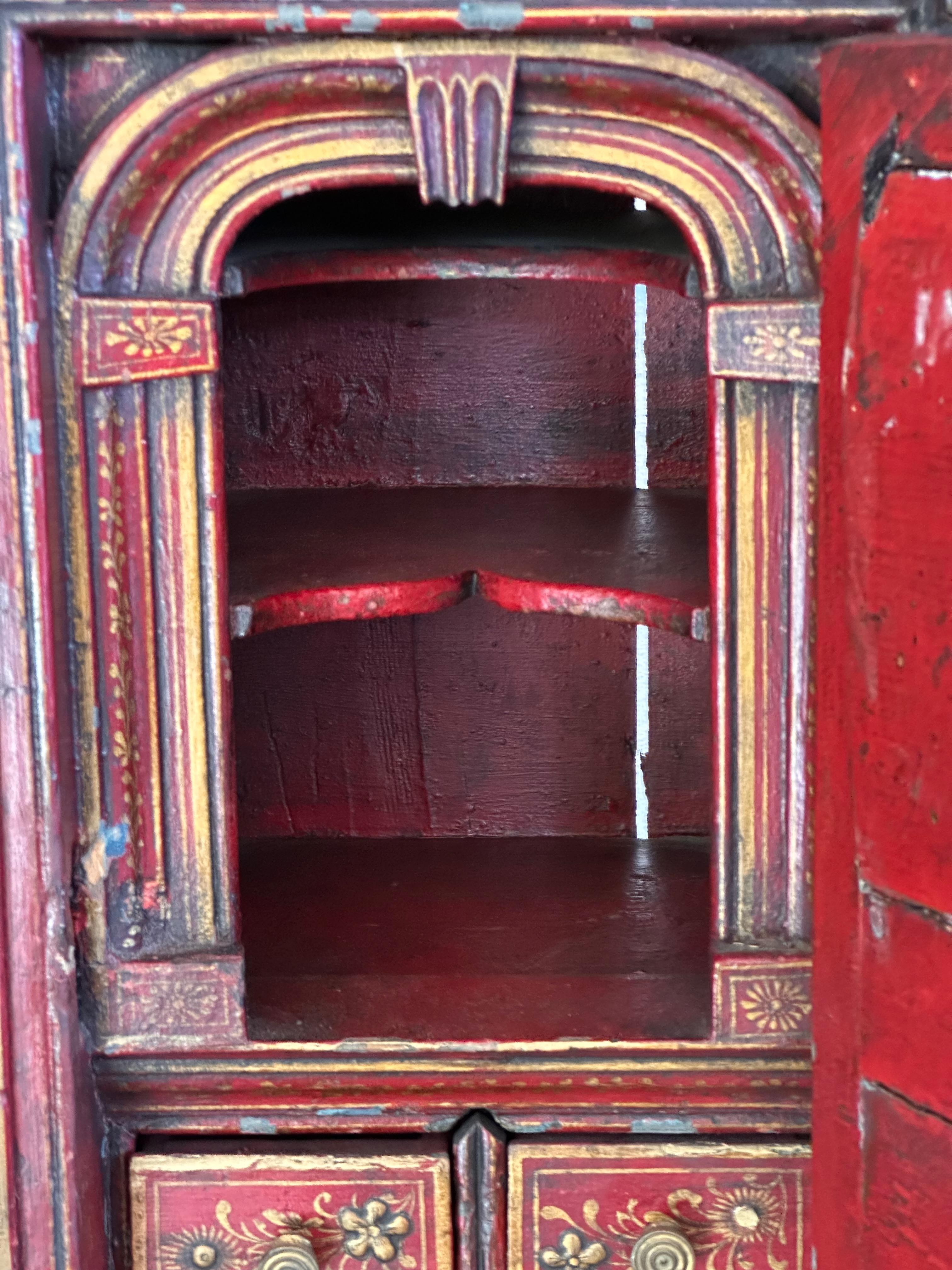 So much to love. Red chinoiserie decoration. Lots of compartments.