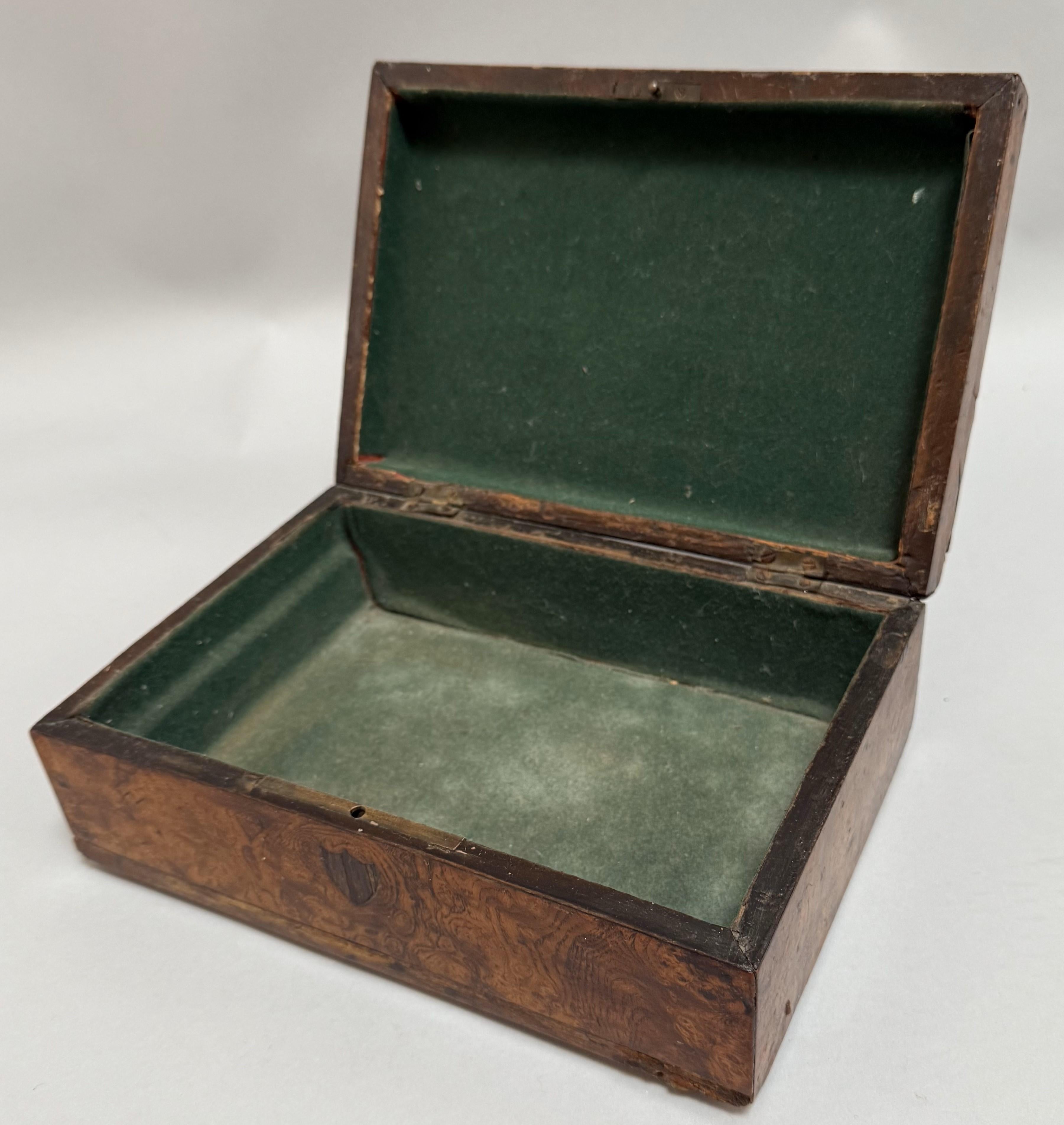 Late 18th Century George III English Box. Veneered in beautifully highly figured burled ash with small inlaid shield shapes. Made in England circa 1790.

A beautifully crafted late 18th century George III box, made in England circa 1790. This