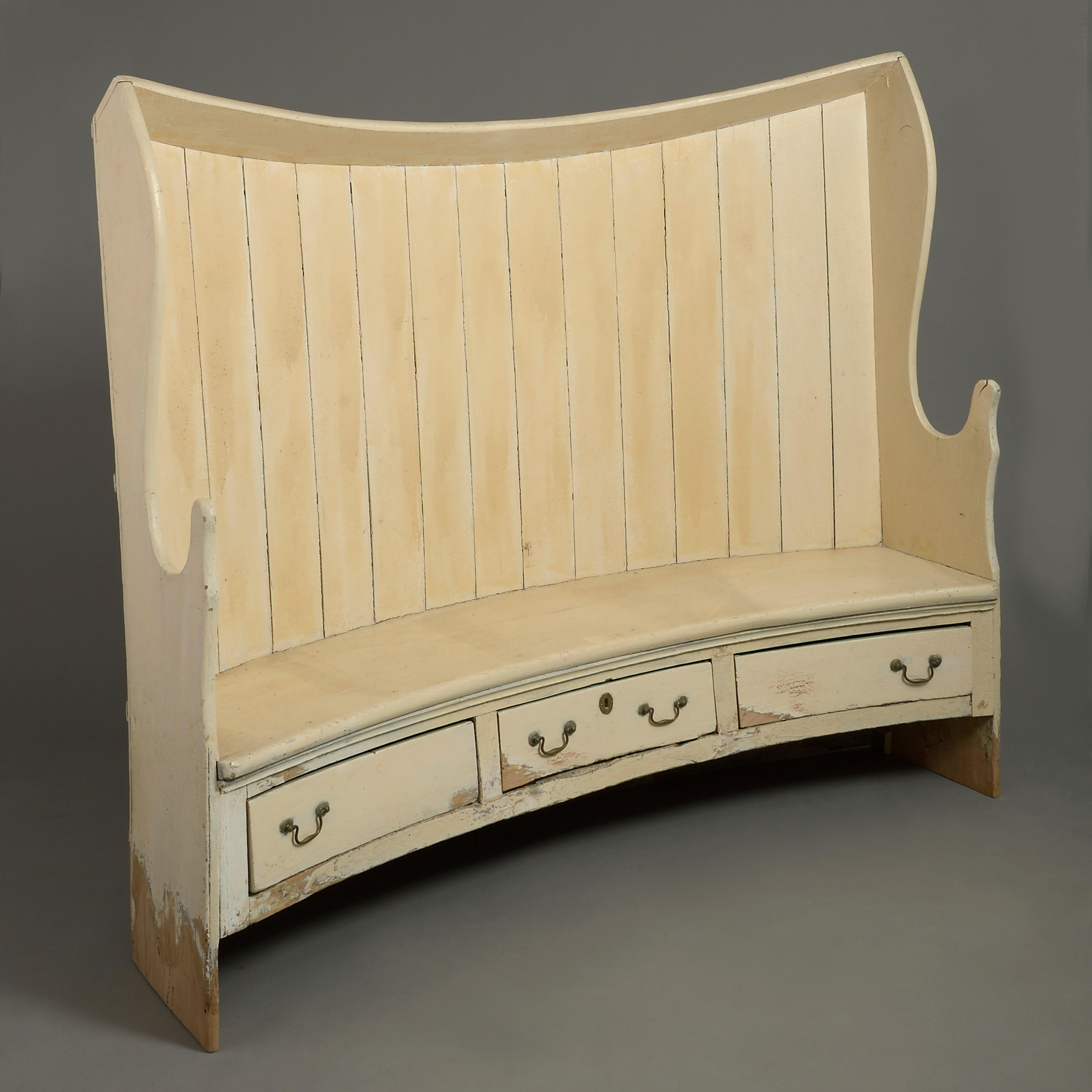 A charming late 18th century cream painted settle, the curved boarded back having shaped arm rests, the bench seat raised upon three drawers with brass swan neck handles.