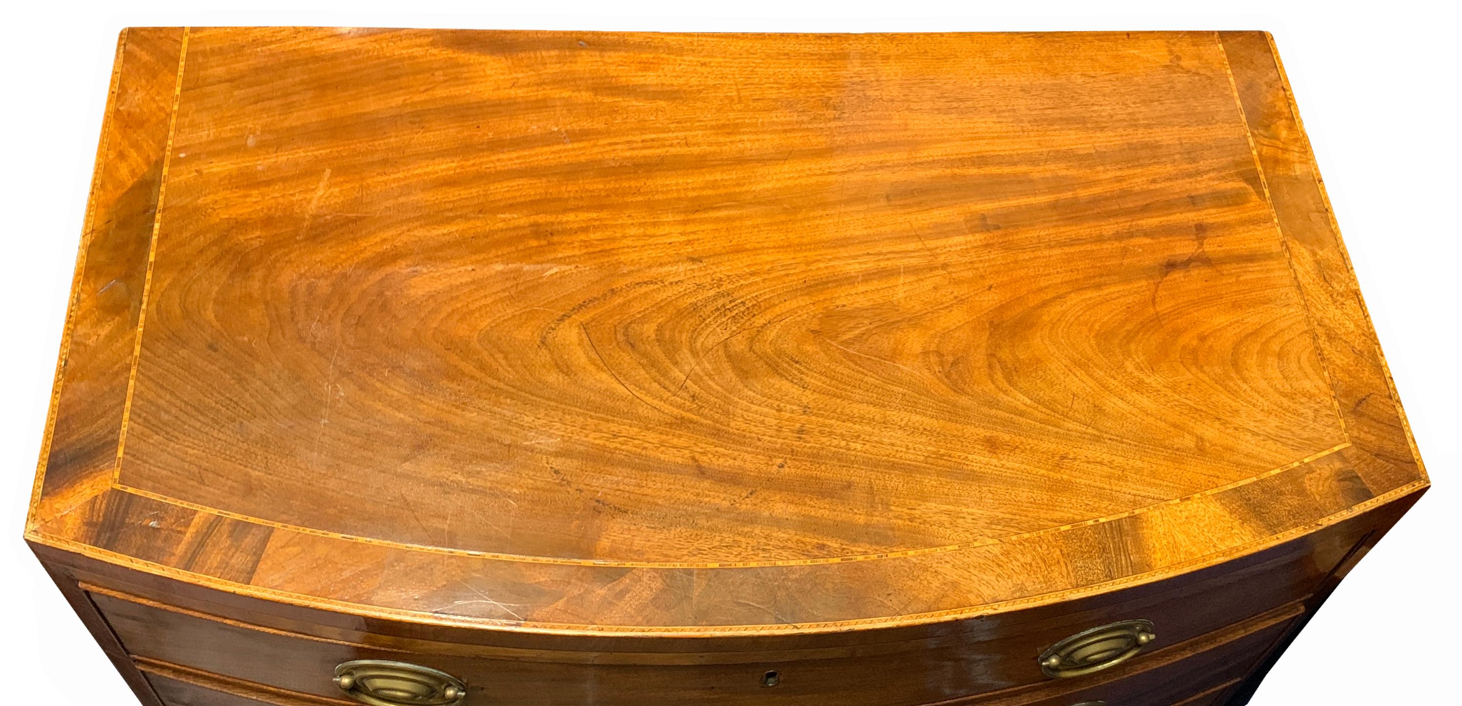 A superb quality George III period mahogany bow
fronted chest having superbly figured and inlaid
crossbanded top over four long cedar lined
drawers with replacement brass oval plate handles
raised on elegant original splay feet with shaped