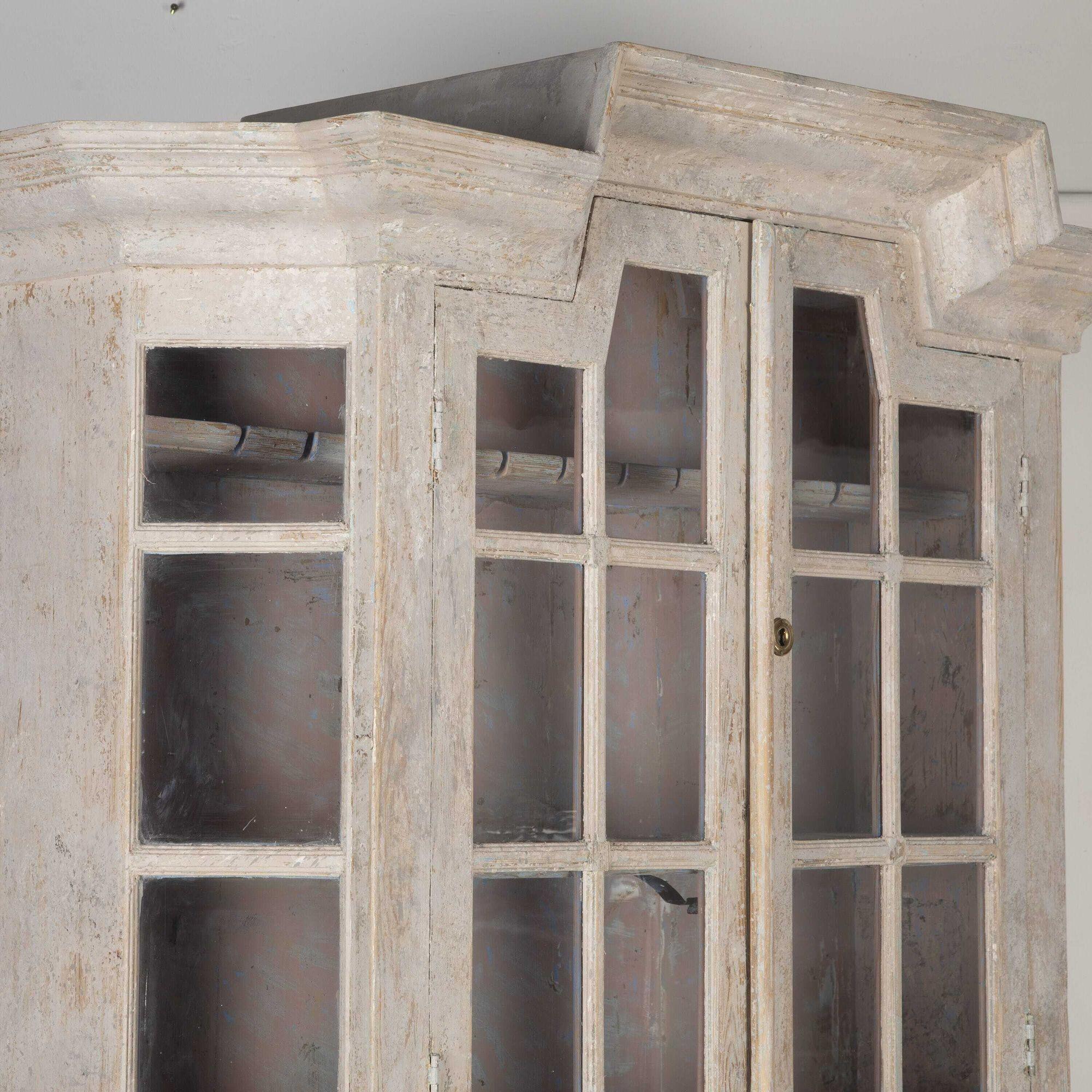 Late 18th century painted Gustavian cabinet.
Featuring a pair of glazed doors over two panelled doors with period escutcheons (not original to the piece) and later locks and hinges.
The interior is beautifully dry scraped to old pink paint.
A