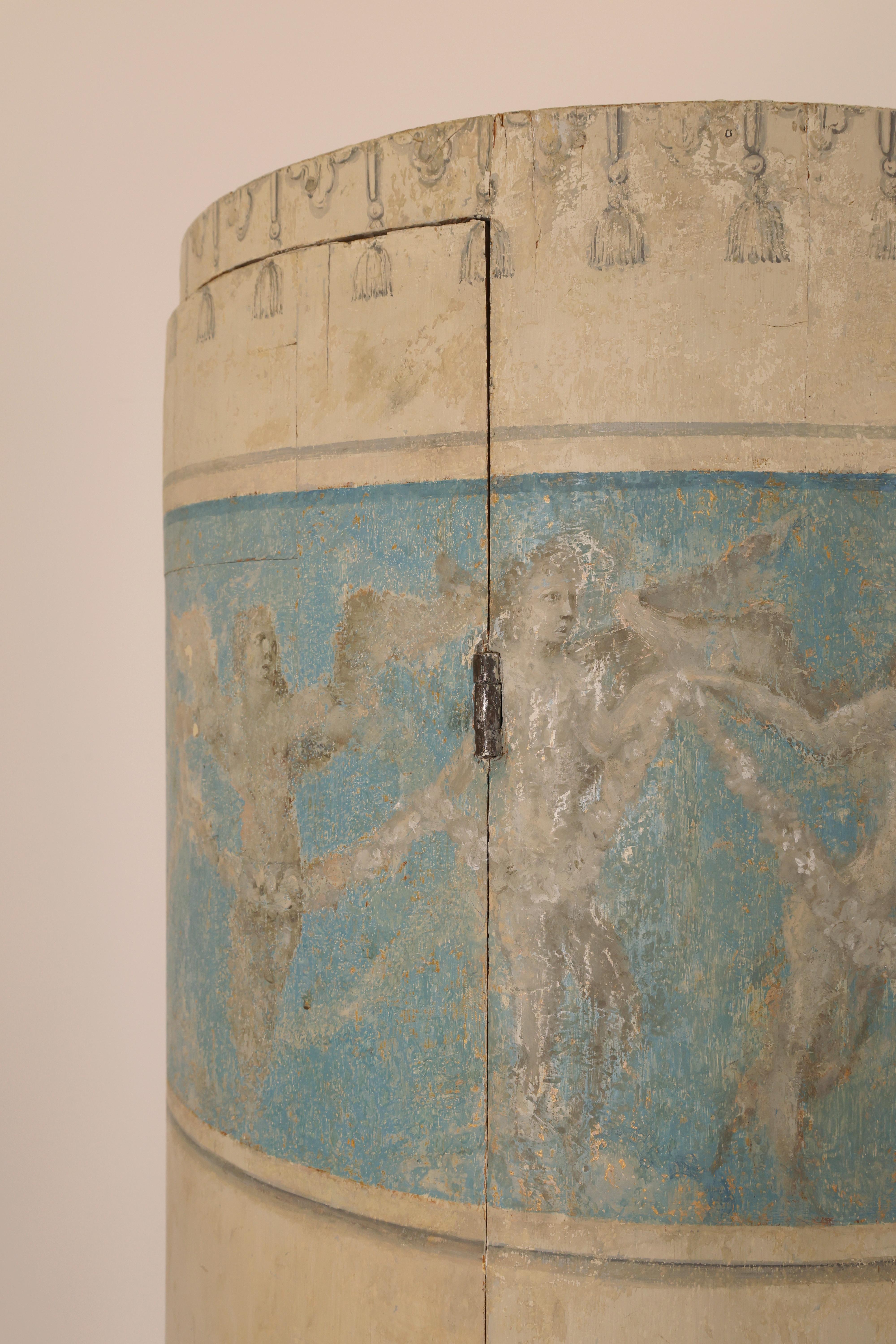 A Gustavian column cabinet from around the 1780s/1790s, most likely made in Stockholm, Sweden. The cabinet features two opening doors with working locks. The original painting (retouched with repairs) has a beige base color with painted fluted